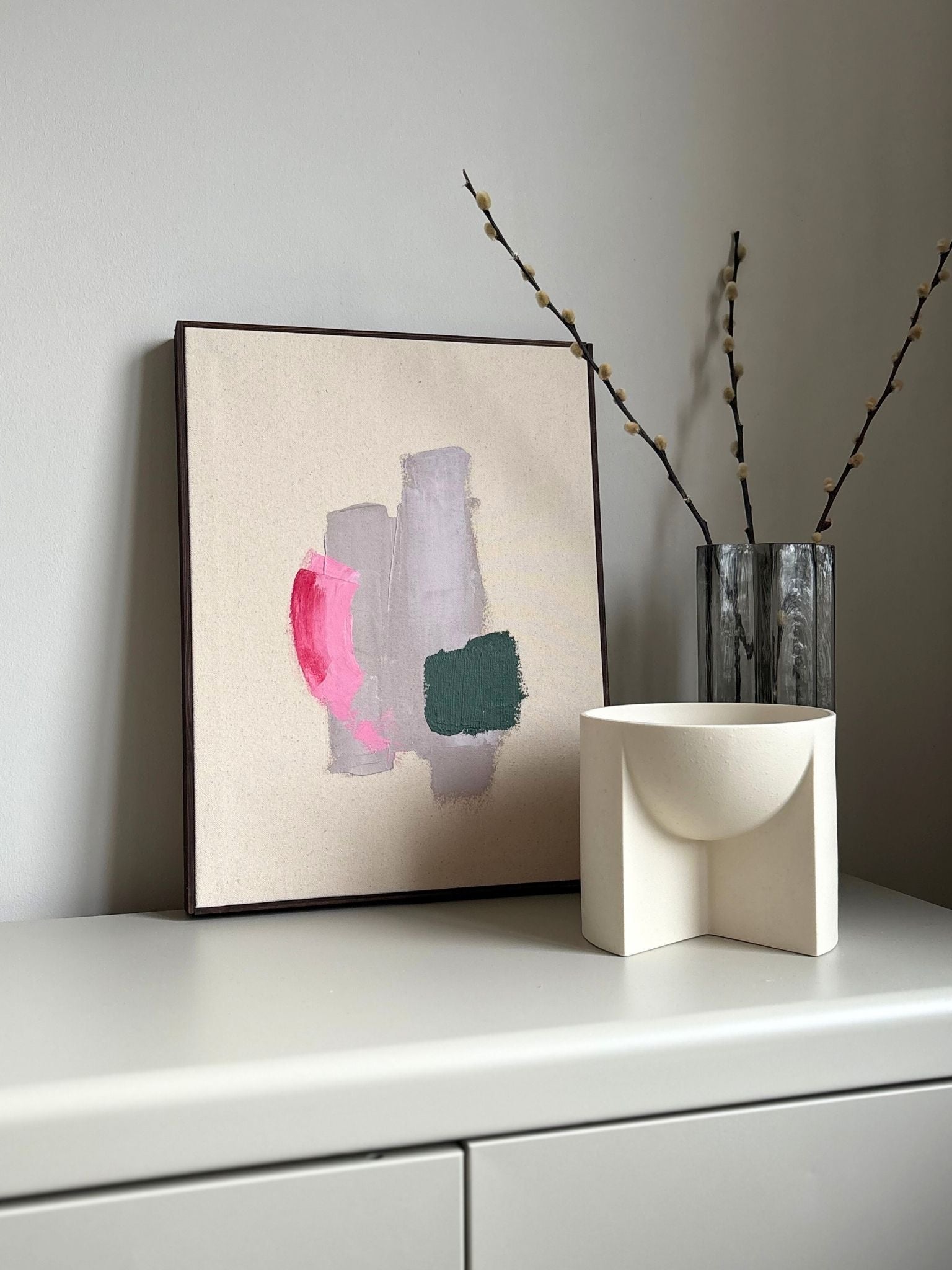 Finished framed abstract painting made using Plan’s Mix (primary colours) palette, with overlapping colour blocks in green, pink and beige on raw cotton canvas, photographed in soft natural light as modern home decor.