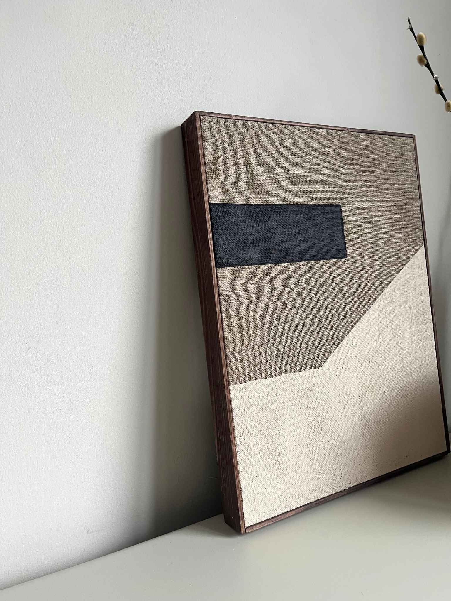Handcrafted framed monochrome linen canvas artwork featuring bold black forms and soft neutral tones, created from Plan’s monochrome linen palette and photographed as minimalist wall art.