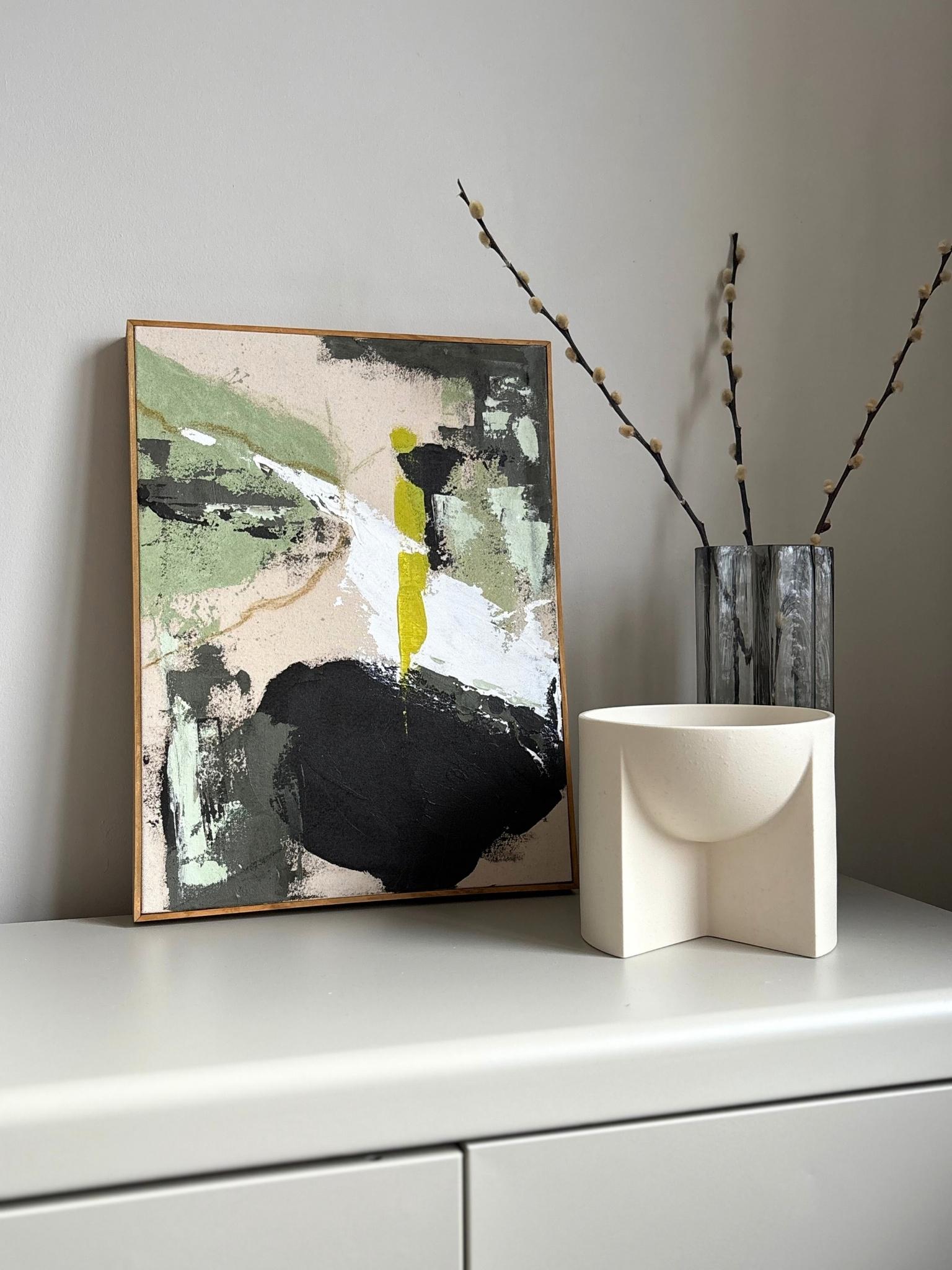 Finished abstract framed canvas artwork created with the Plan Olive palette, showcasing soft olive green, muted black, beige and white brushstrokes on raw cotton canvas, finished with a handcrafted oak edge frame.