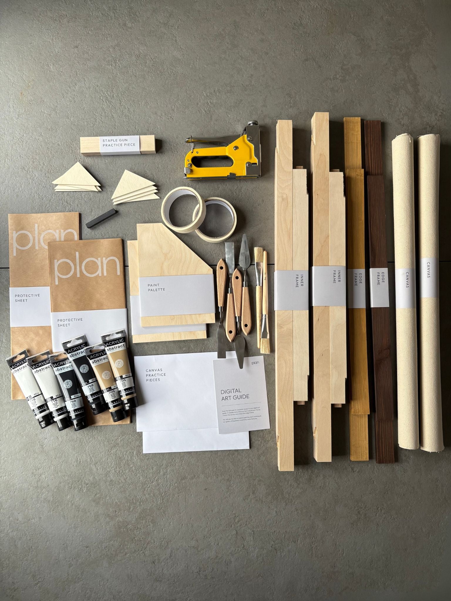Flatlay of large Monochrome 01 Double DIY Art Kit 50x70 cm with oak and dark oak edge frames, beige black and white paint set, brushes and masking tape — modern DIY art kit for home decor UK.