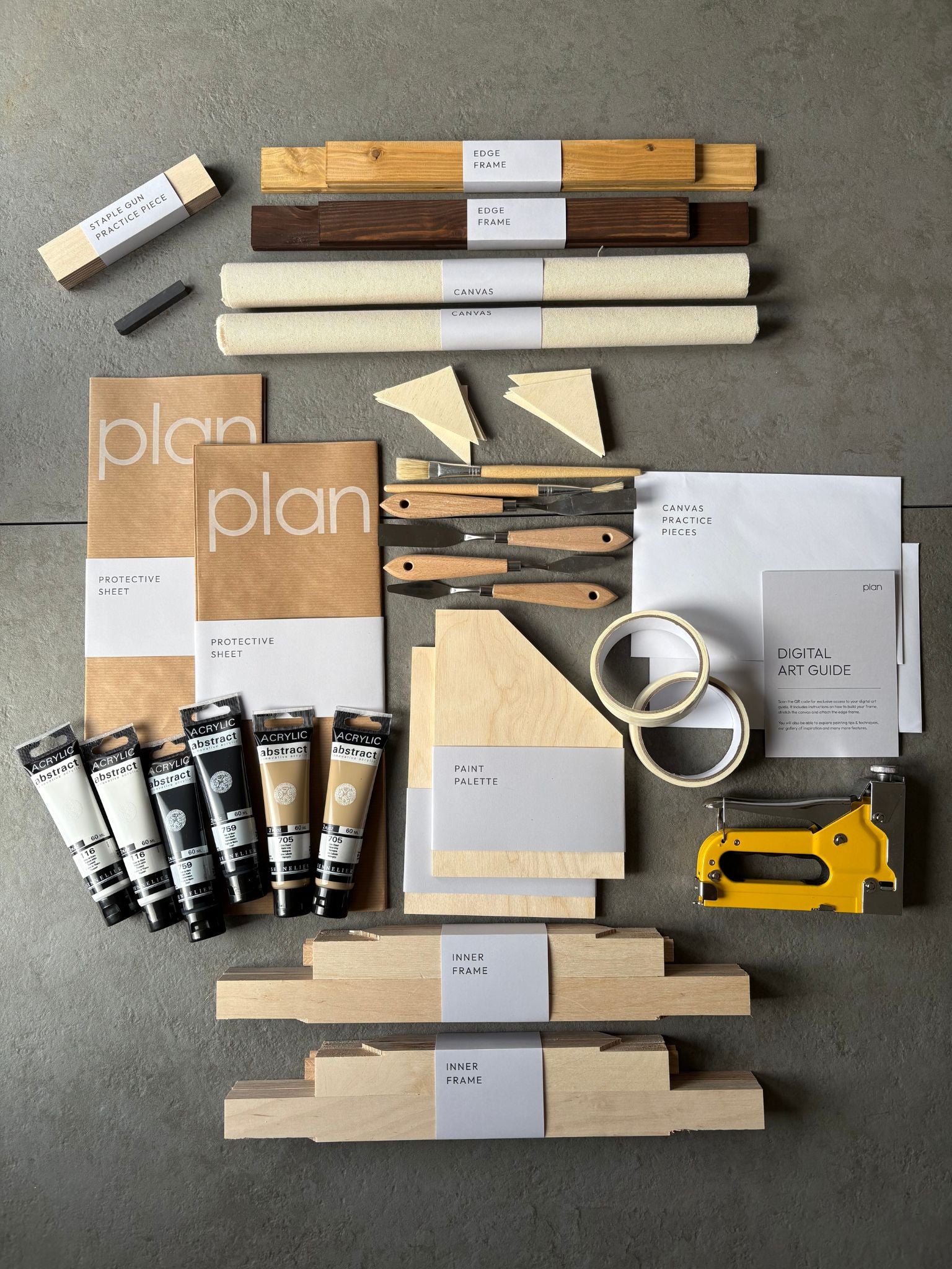 Flatlay of Monochrome 01 Double Art Kit 30x40 cm with oak and dark oak edge frames, black white and beige paints, masking tape, brushes, palette knife and cotton canvas — premium DIY art kit for modern homes UK.