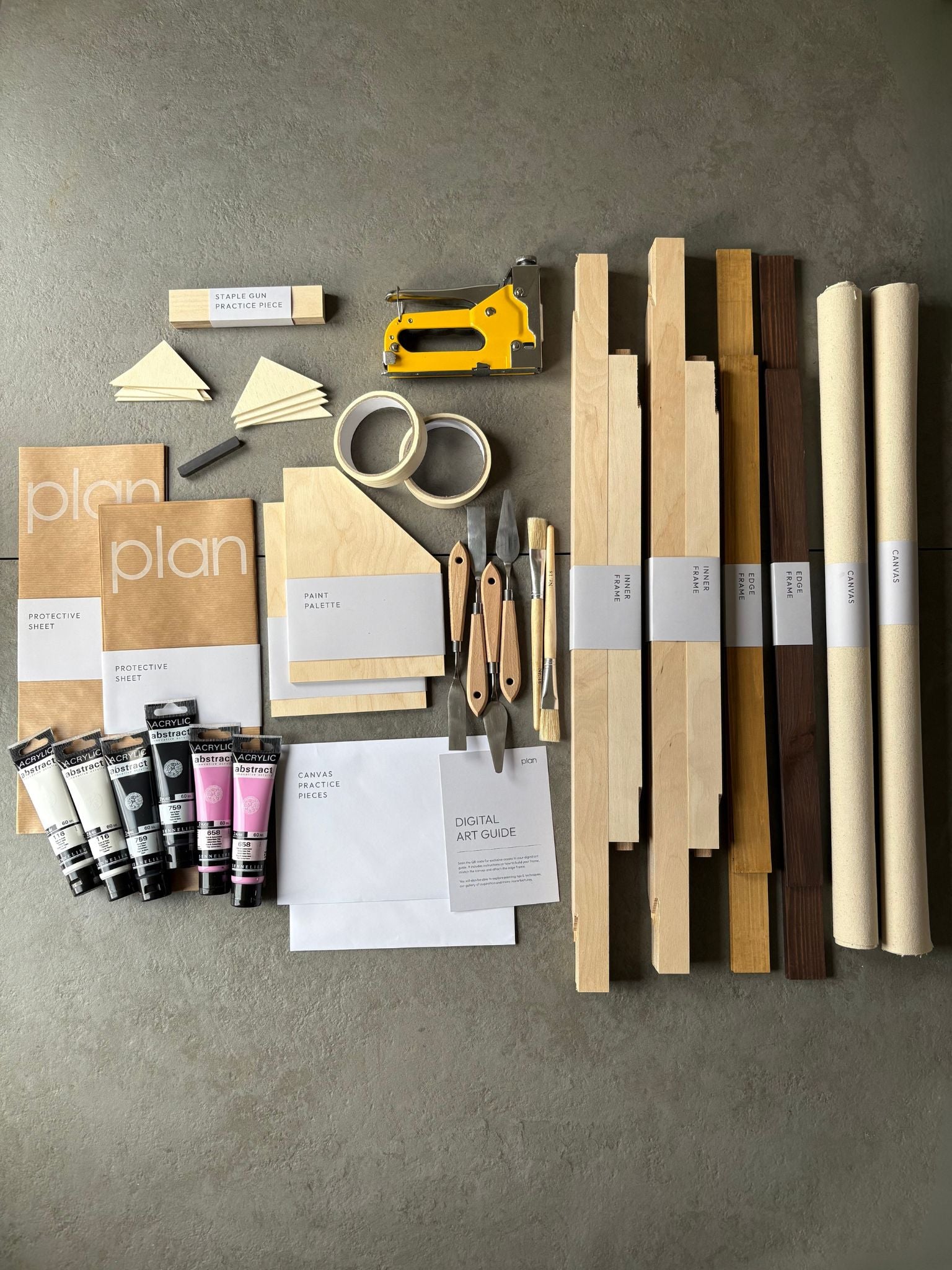 Flatlay of Monochrome 01 Double Kit 50x70 cm with oak and dark oak frames, black white and pink paints, artist tools and cotton canvas — luxury DIY art kit UK for creative gift ideas.