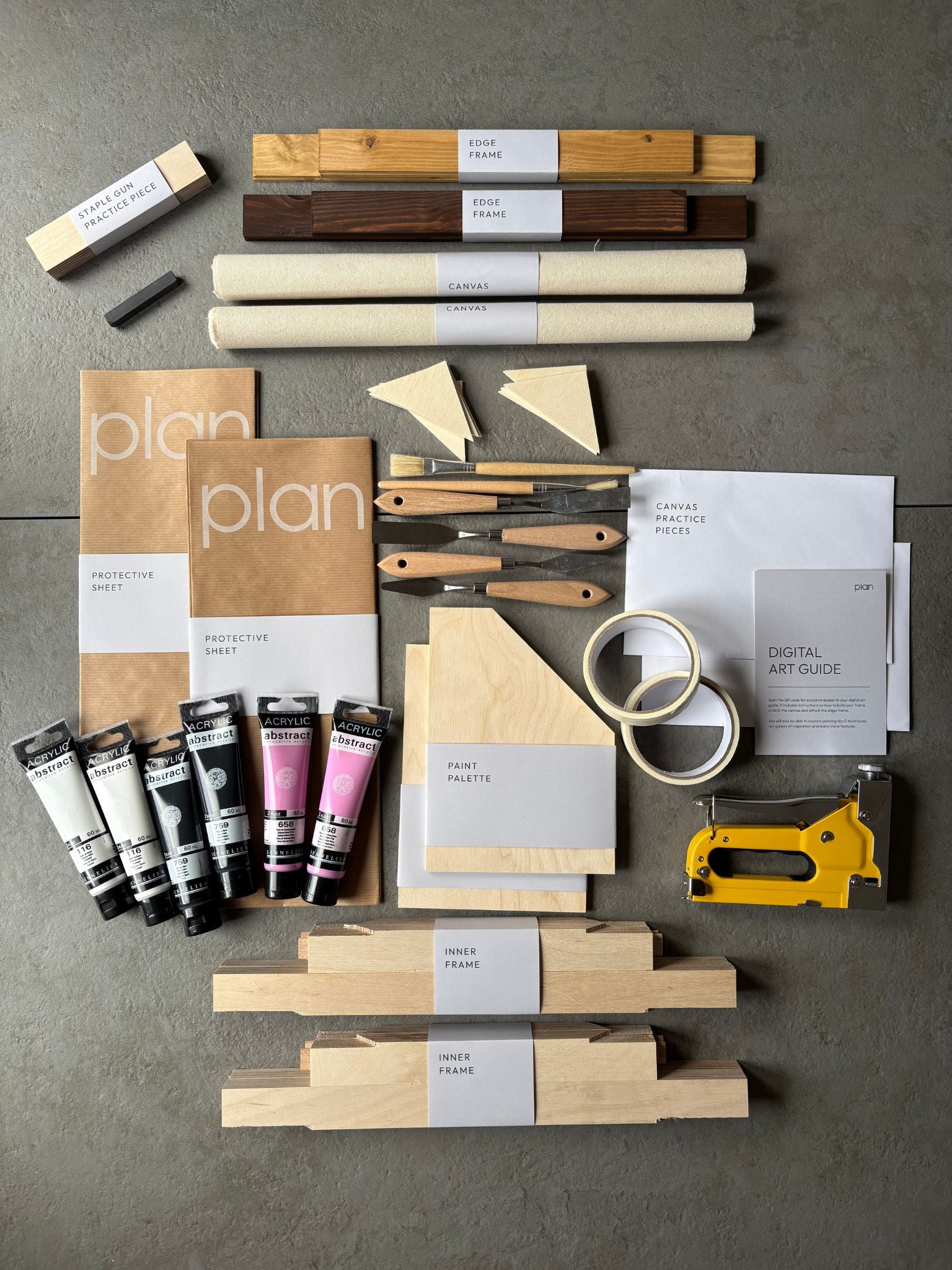 Flatlay of Monochrome 01 Double DIY Art Kit 30x40 cm with oak and dark oak frames, black white and pink paints, masking tape, artist tools and cotton canvas — create bold minimal art at home UK.