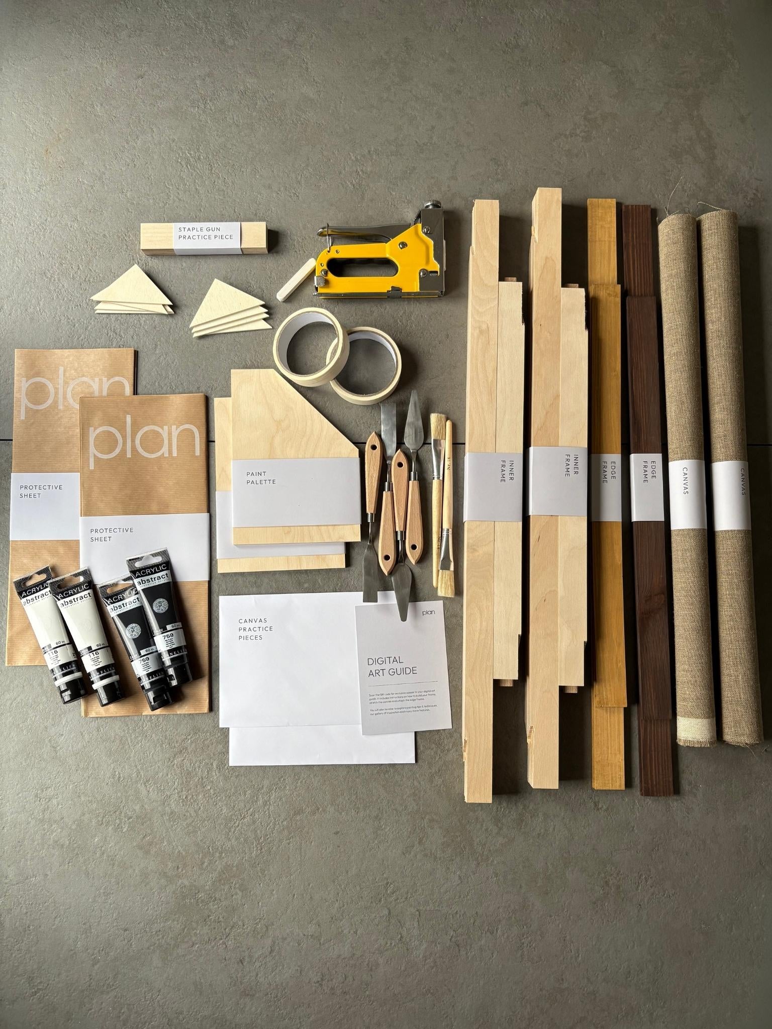 Flatlay of large Monochrome 02 Double DIY Art Kit 50x70 cm with oak and dark oak edge frames, black and white paints, white soft pastel, artist tools and linen canvas. Premium DIY monochrome art kit UK for creative gift ideas and home interiors.