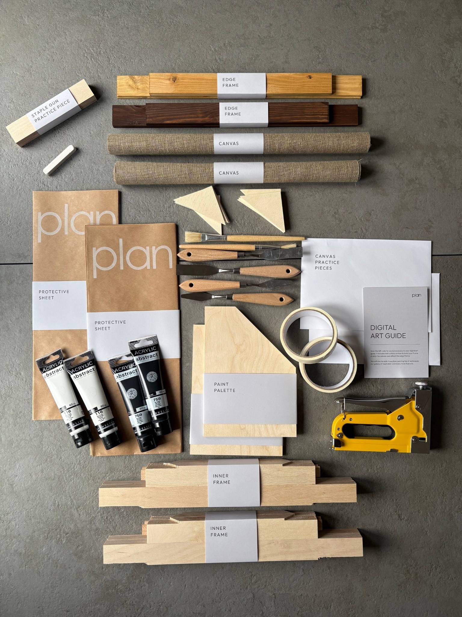 Flatlay of Monochrome 02 Double DIY Art Kit 30x40 cm with oak and dark oak edge frames, black and white paints, white soft pastel, masking tape, brushes, palette knife and linen canvas. Minimal monochrome art kit UK for modern home decor.