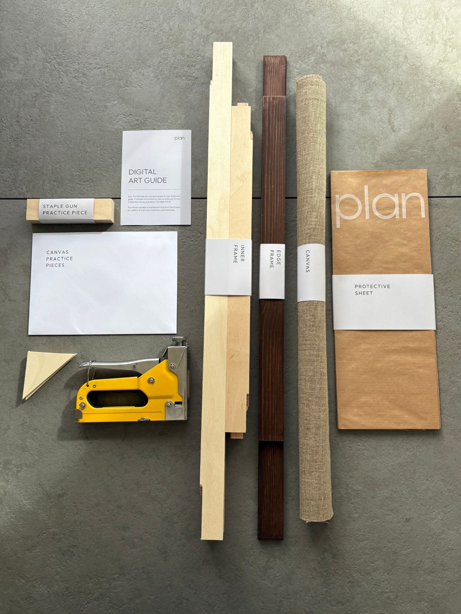 See the contents of the Plan Blank Canvas Art Kit in frame size 50x70cm, dark oak stain. Handcrafted frame with raw linen and all the tools you need to put it together.