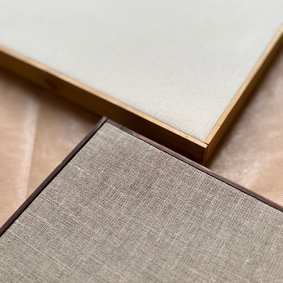 Two framed canvases in cotton and raw linen showing texture differences used in premium DIY framed canvas art kits.
