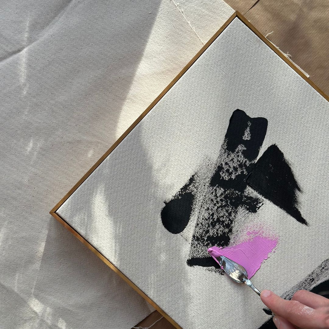 Close-up of expressive brushwork and acrylic paint on raw canvas created using a DIY framed canvas art kit.