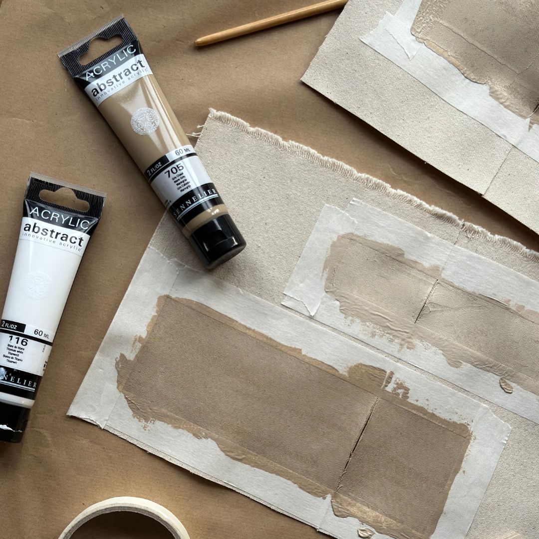 Canvas practice pieces with acrylic paint tests used to explore colours and techniques before painting the main artwork.