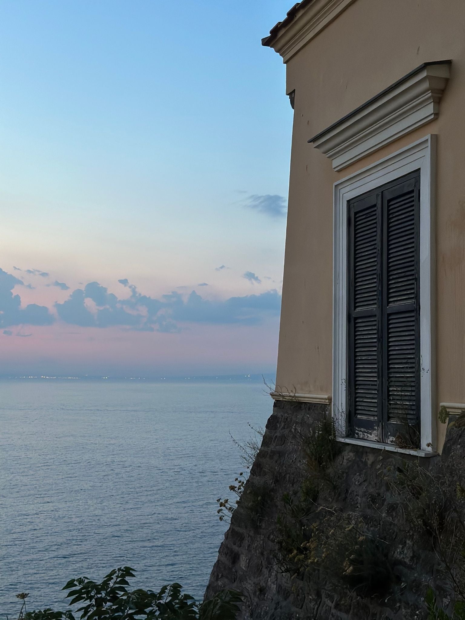 Coastal building overlooking the sea with strong blocks of colour and soft evening light, inspiring the bold, expressive tones of the Primary Colours framed canvas art kit.