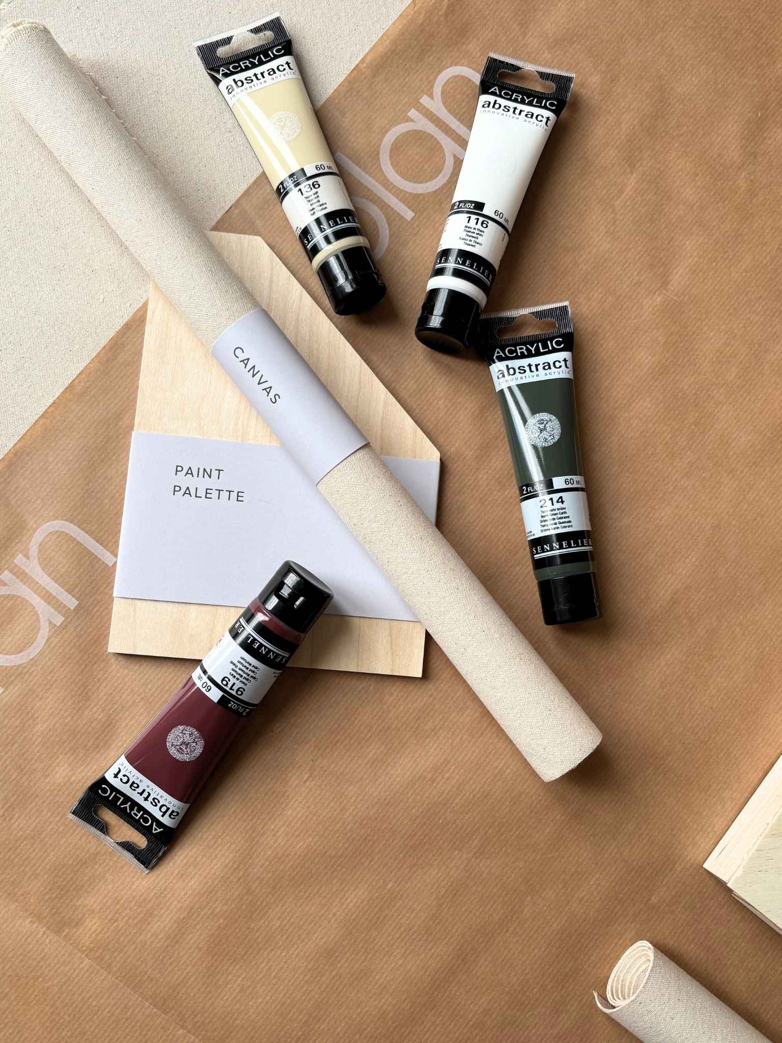 Close-up of the Forest Red colour palette from a DIY abstract art kit, featuring rich red and green, neutral and earthy acrylic paints alongside cotton canvas and wooden paint palette for creating modern wall art at home.