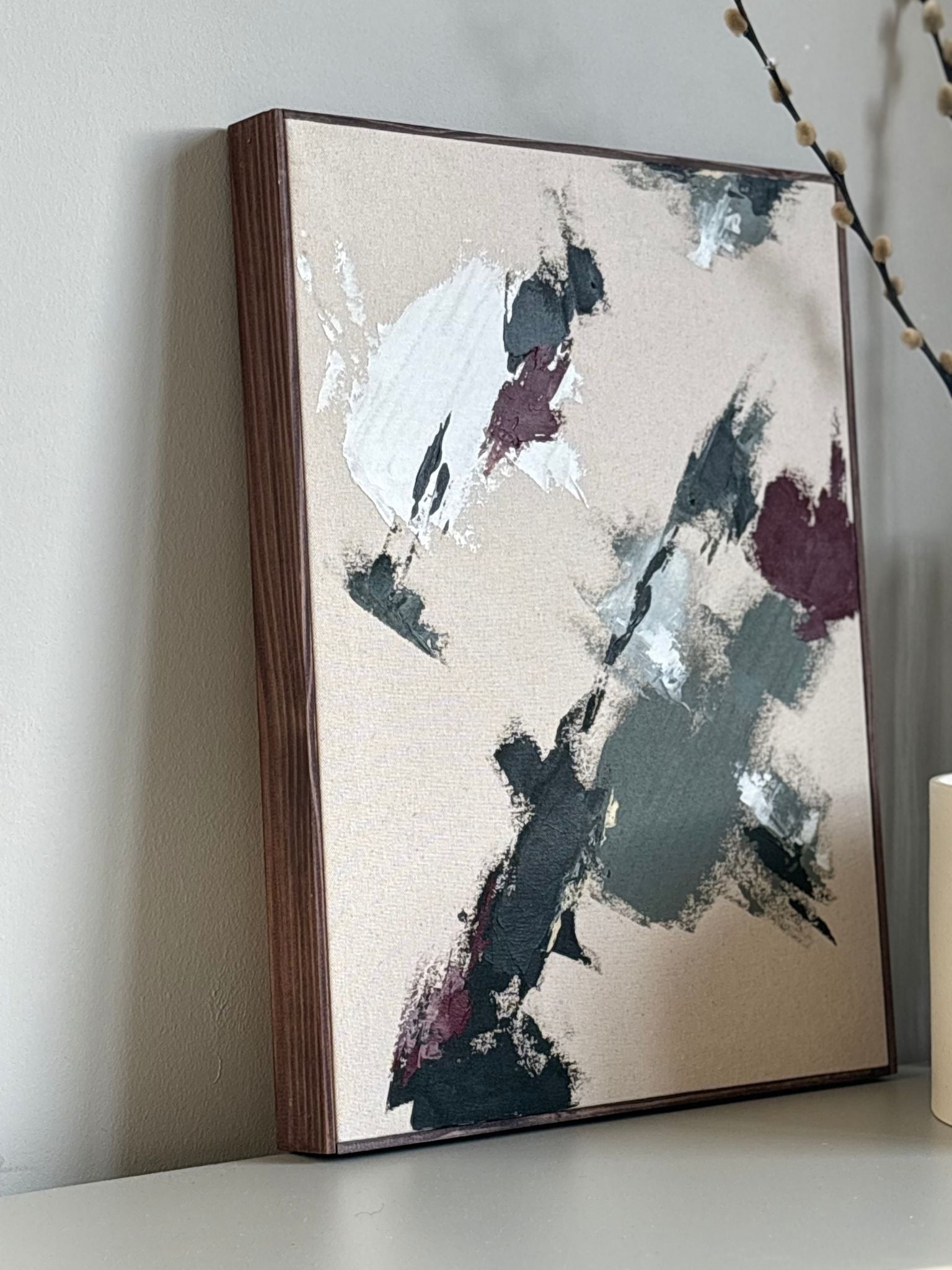 Abstract framed canvas artwork in forest red colour palette, DIY artwork created with the Forest Red framed canvas art kit, styled on a shelf in a modern home