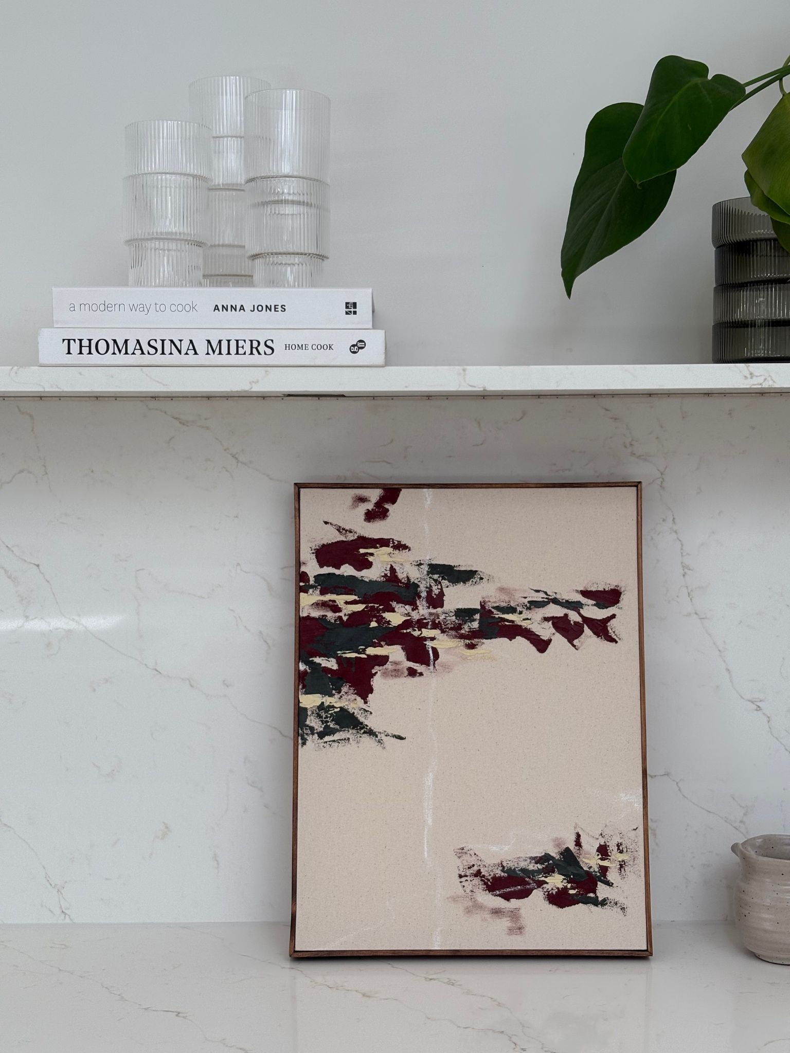 Handmade abstract canvas artwork in forest red palette, framed canvas art created using a DIY art kit and styled on open shelving