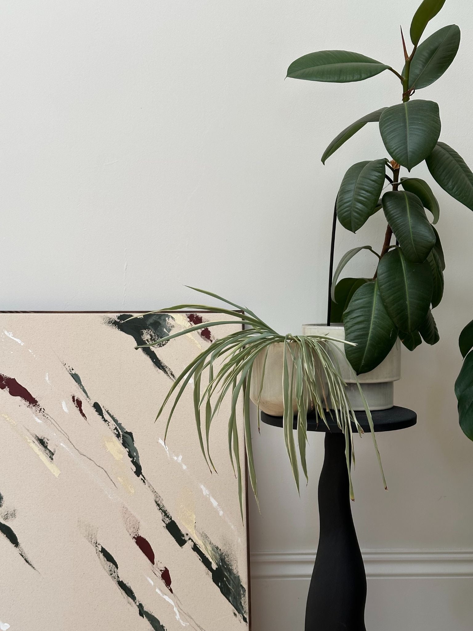 Large abstract framed canvas artwork in forest red tones, DIY artwork created with the Forest Red framed canvas art kit and styled with indoor plants