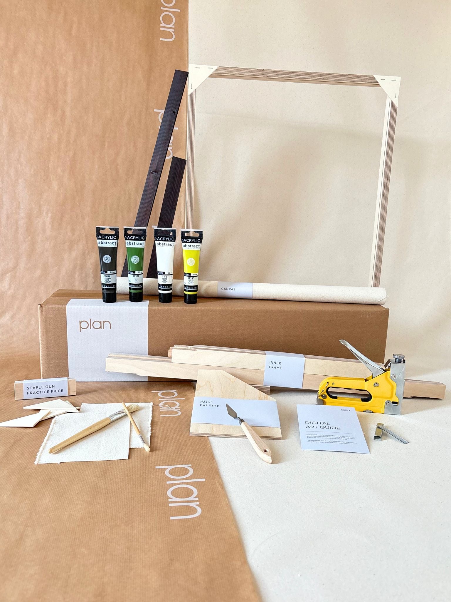 Olive framed canvas art kit by Plan, medium 50 x 70 cm size with dark oak edge frame, showing frame, cotton canvas, acrylic paints and art tools