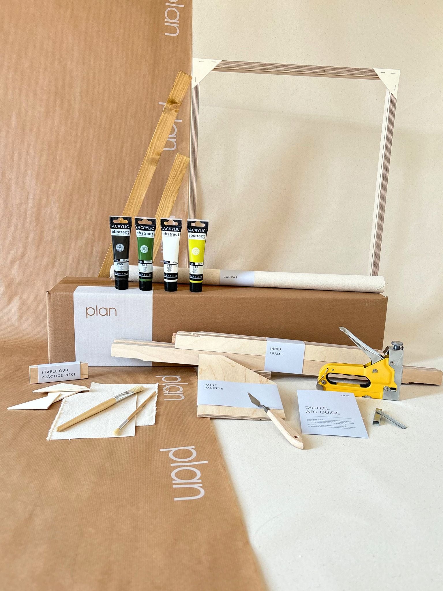 Olive framed canvas art kit by Plan, medium 50 x 70 cm size with oak edge frame, showing frame, cotton canvas, acrylic paints and art tools