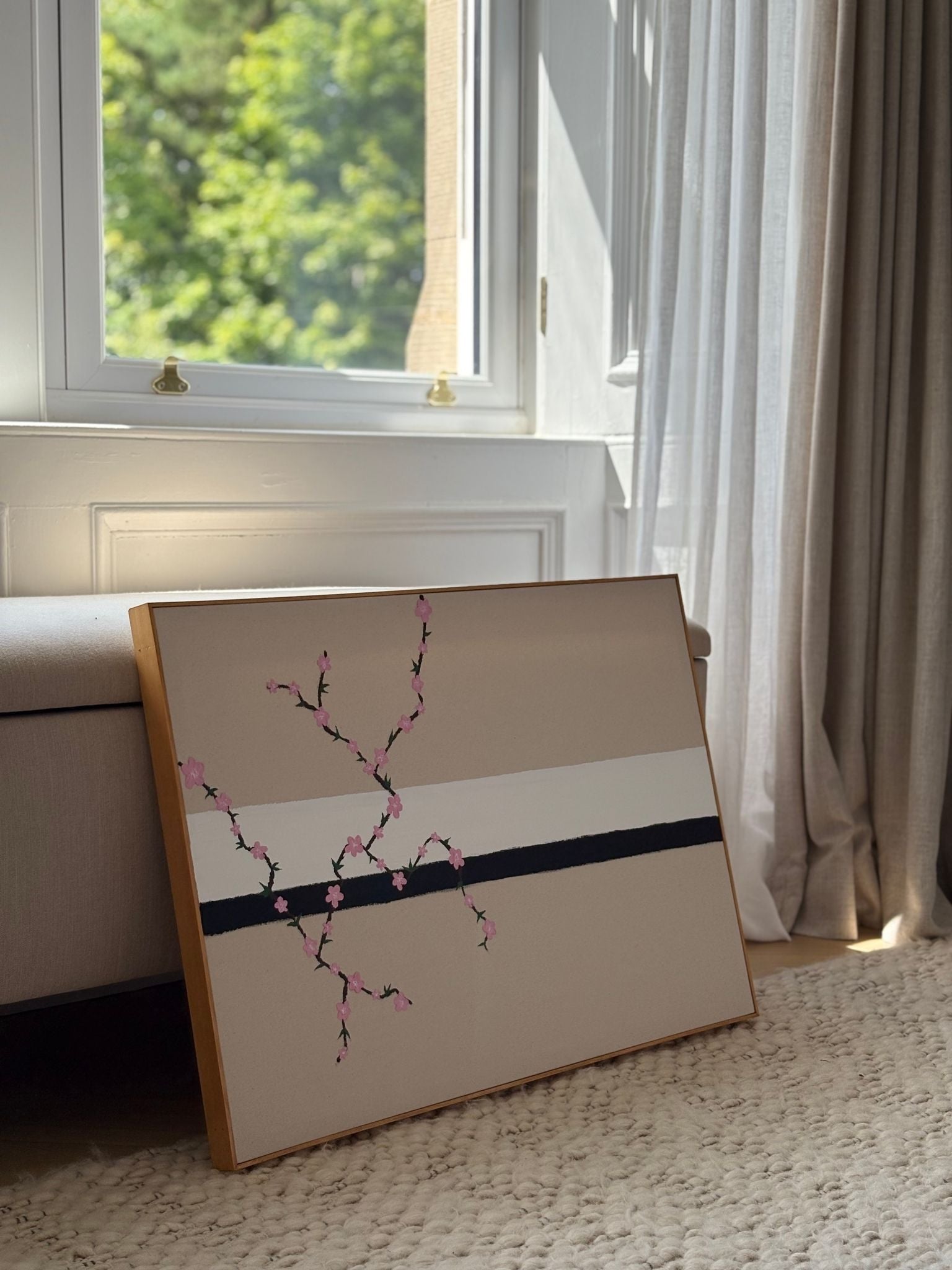 Minimal abstract framed canvas artwork inspired by colour mixing, featuring delicate painted branches and soft neutral tones, styled on the floor near a window with natural light.