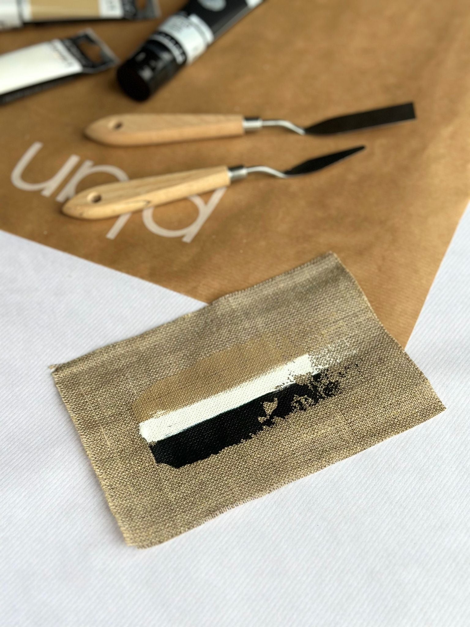 Monochrome colour palette swatch for Plan framed canvas art kit on linen canvas, featuring black, white and soft beige acrylic paints with natural texture