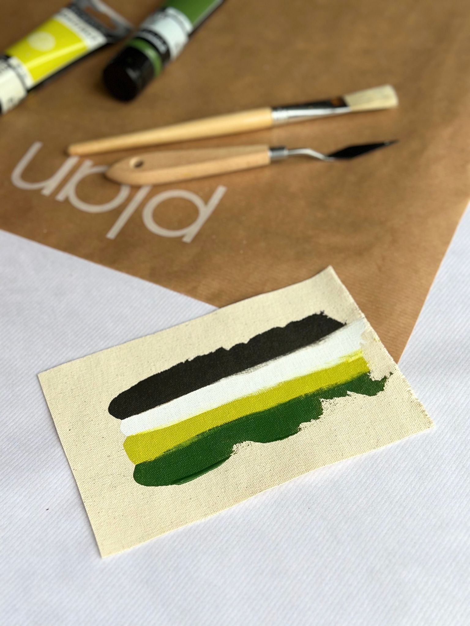 Olive colour palette swatch for Plan DIY framed canvas art kit, featuring olive green, green, white and earthy tones painted on cotton canvas with artist palette knives