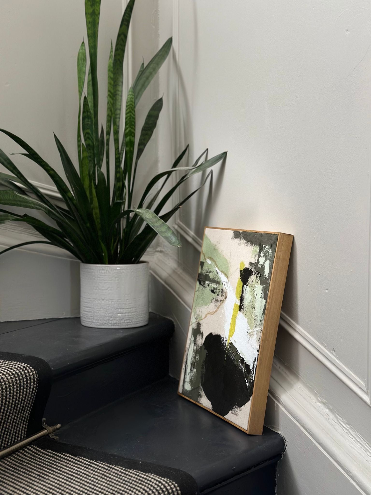 DIY canvas artwork made using the Plan framed cotton canvas kit, showing olive green abstract marks on a handmade stretched canvas