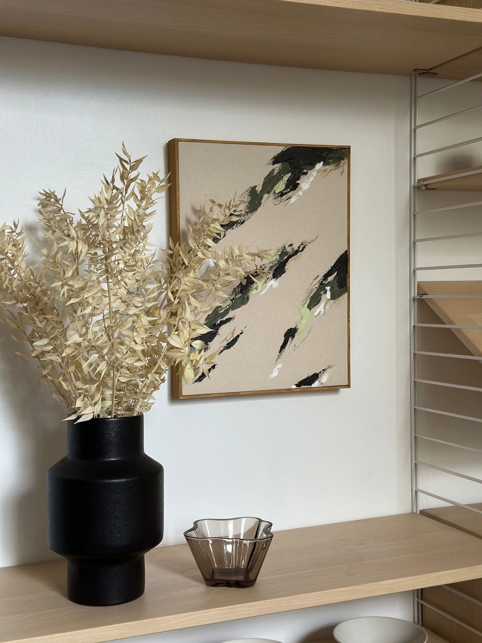 Framed abstract canvas art in olive tones, created using the Plan DIY framed canvas art kit with a solid handmade frame and cotton canvas, styled in a modern home interior