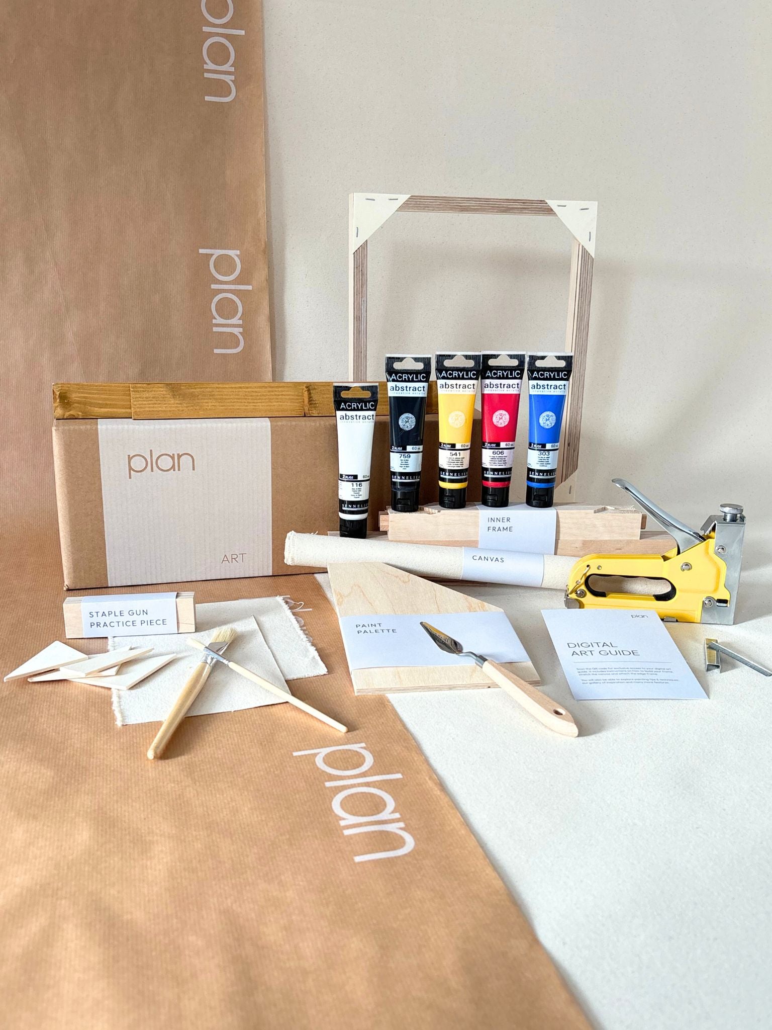 Colourful abstract framed canvas art created using primary paints, styled on a shelf with sculptural decor and dried branches, showcasing creative freedom and expressive mark-making.