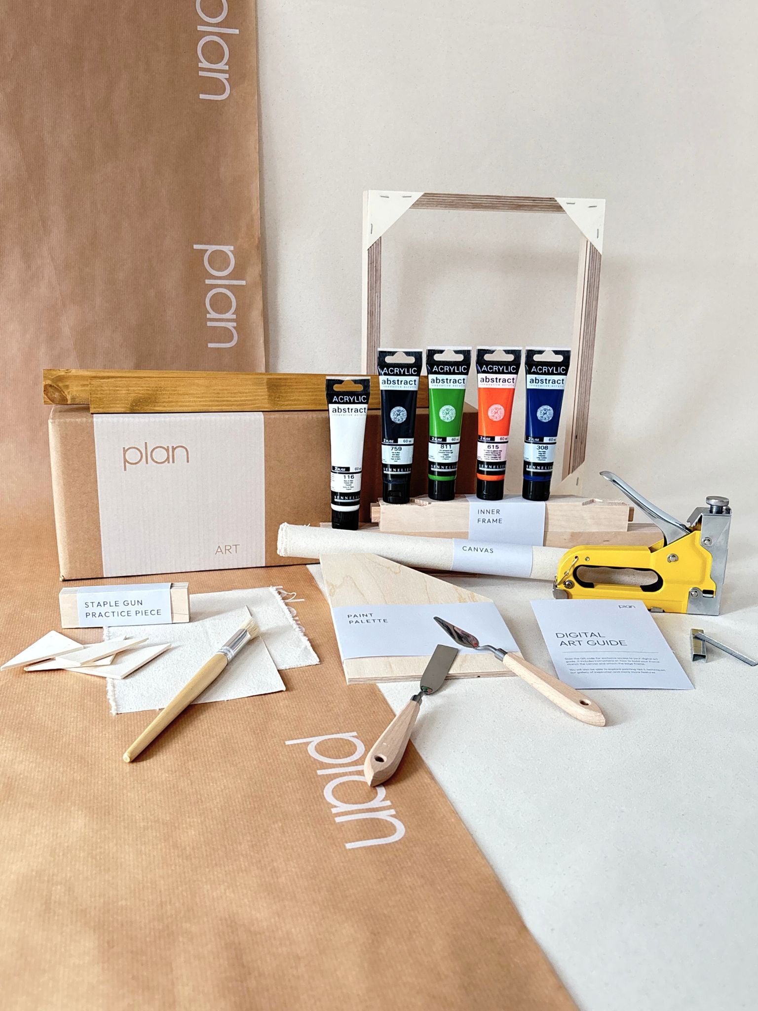 DIY framed canvas art kit in navy and bright colour palette (navy, black, white, orange and green), small canvas size, with oak edge frame, including paints, custom inner frame, canvas, tools and staple gun