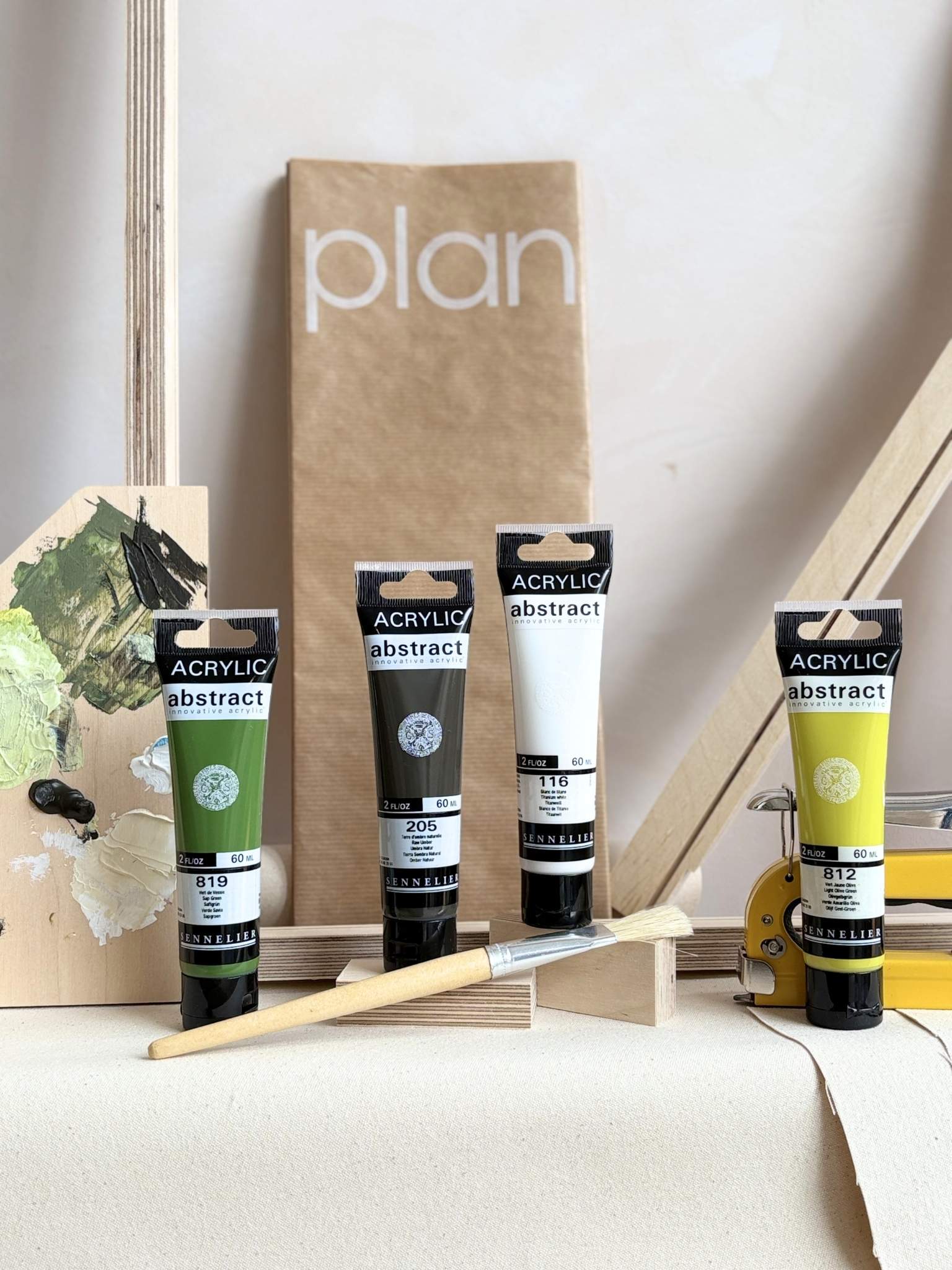 DIY framed canvas art kit with Olive acrylic paint palette, artist tools, canvas fabric, wooden frame pieces and Plan protective sheet.