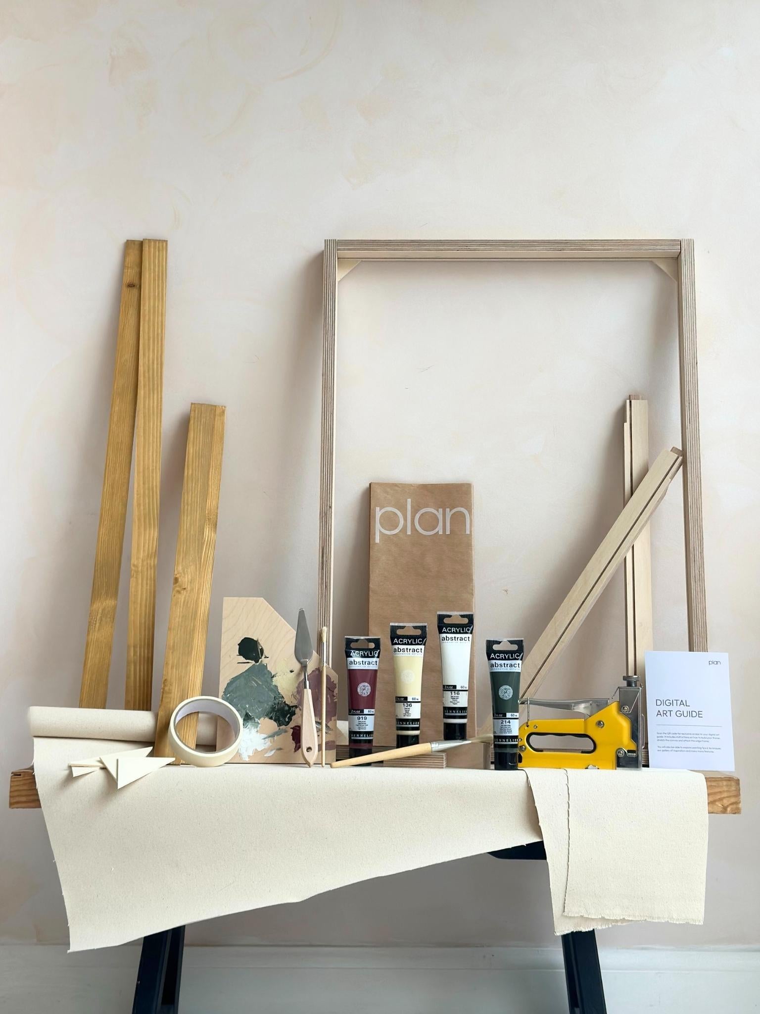 Forest Red framed canvas art kit by Plan, medium 50 x 70 cm size with oak edge frame, showing frame, cotton canvas, acrylic paints and art tools.