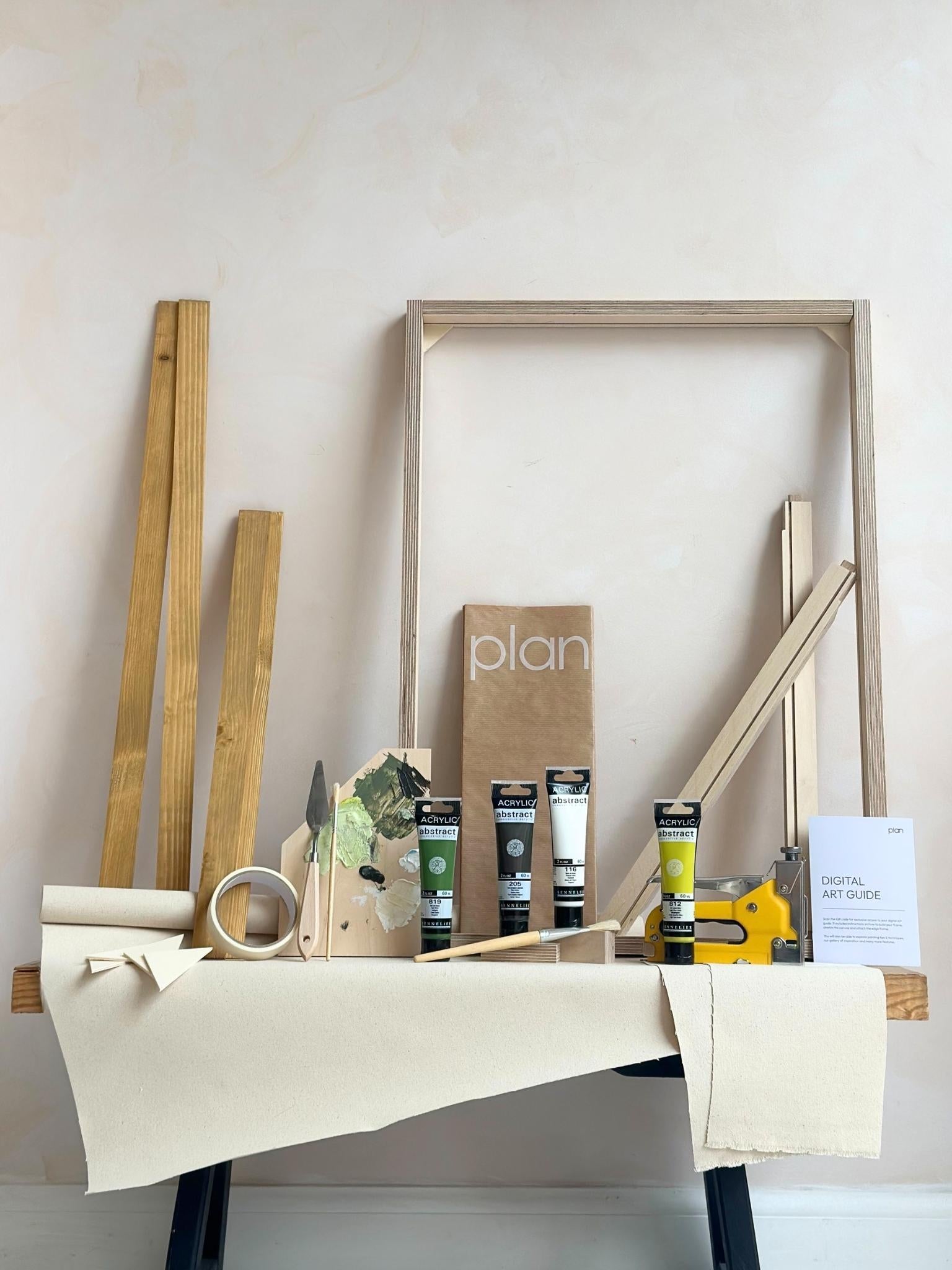 Olive framed canvas art kit by Plan, medium 50 x 70 cm size with oak edge frame, showing frame, cotton canvas, acrylic paints and art tools.