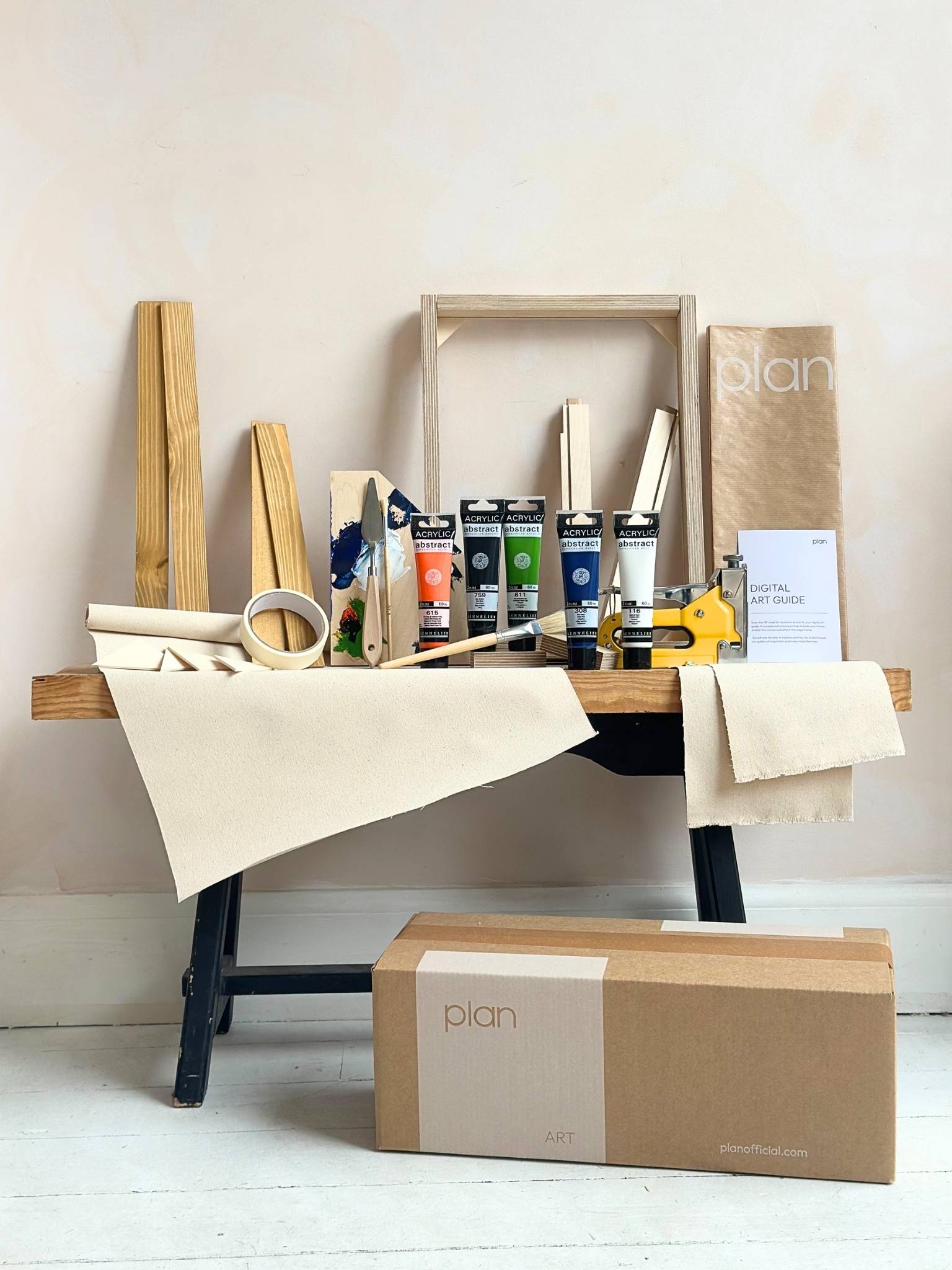 DIY framed canvas art kit in navy and bright colour palette (navy, black, white, orange and green), small canvas size, with oak edge frame, including paints, custom inner frame, canvas, tools and staple gun.