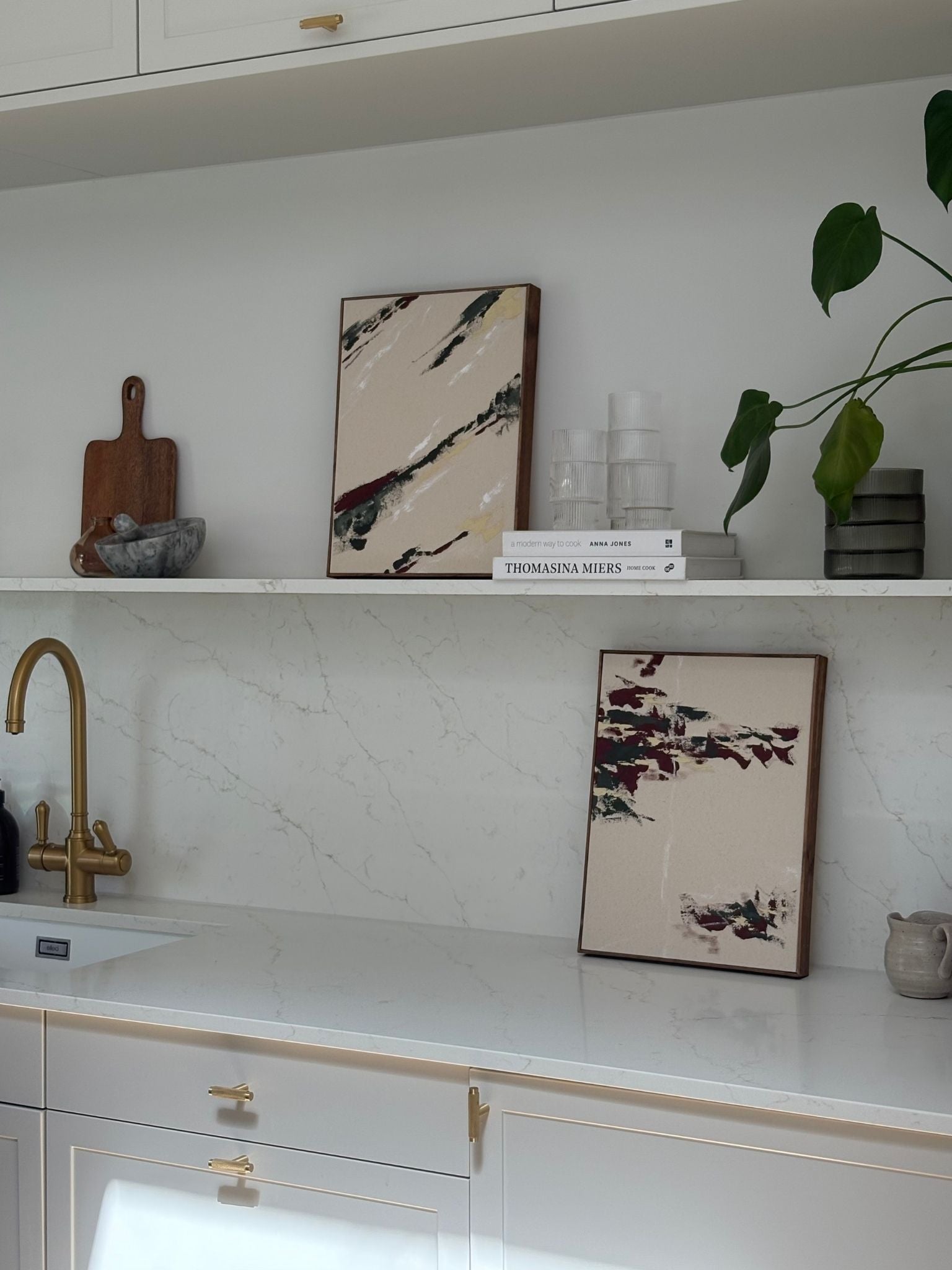 Forest red framed canvas artworks displayed in a modern kitchen setting, showing two finished abstract pieces created from one double art kit.