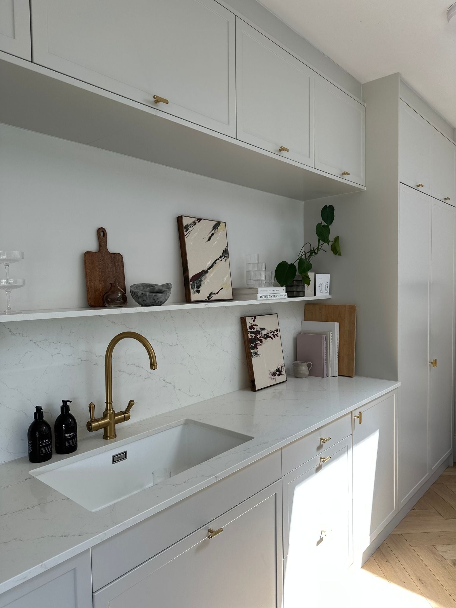 Wide interior view of two forest red abstract artworks styled in a kitchen, demonstrating how a double art kit creates cohesive yet unique framed pieces.