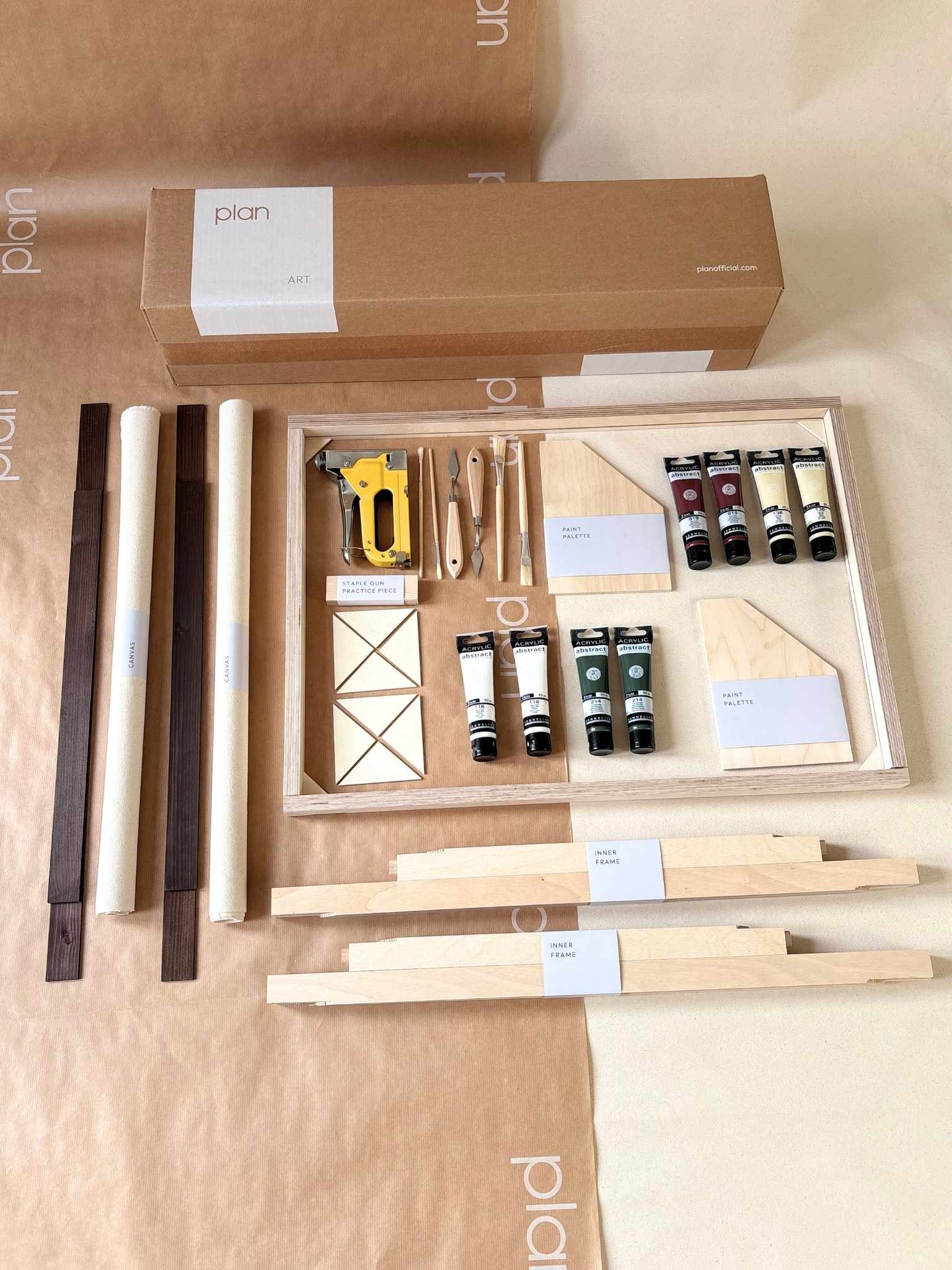 Forest Red double framed canvas art kit showing everything included to create your own art at home, with two canvases, dark oak wooden frames, acrylic paints, painting tools and staple gun arranged as a complete DIY art kit