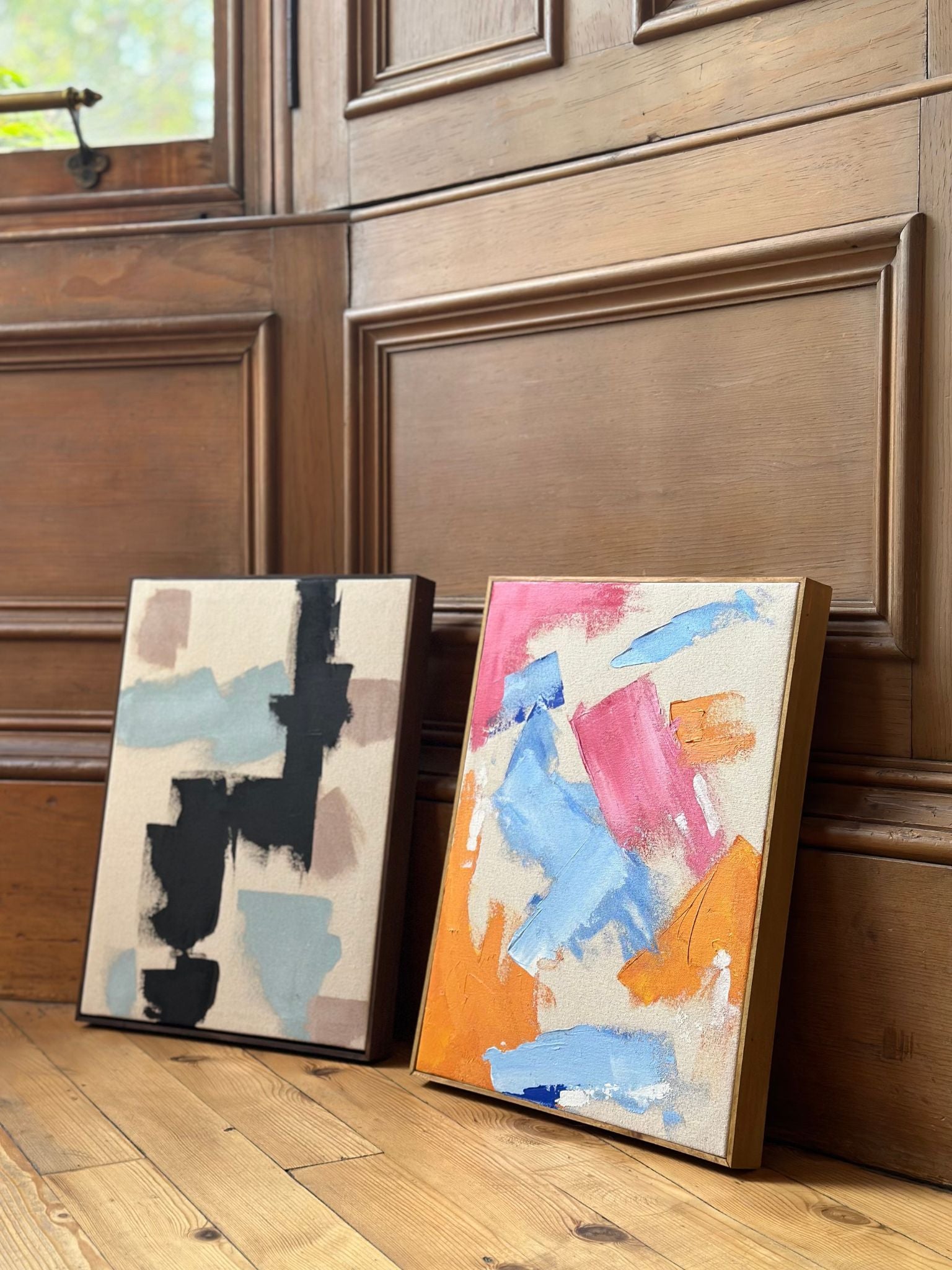 Styled interior scene with two abstract framed artworks made using the MIX primary colours double art kit, designed to create a cohesive pair of bold, modern canvas art.