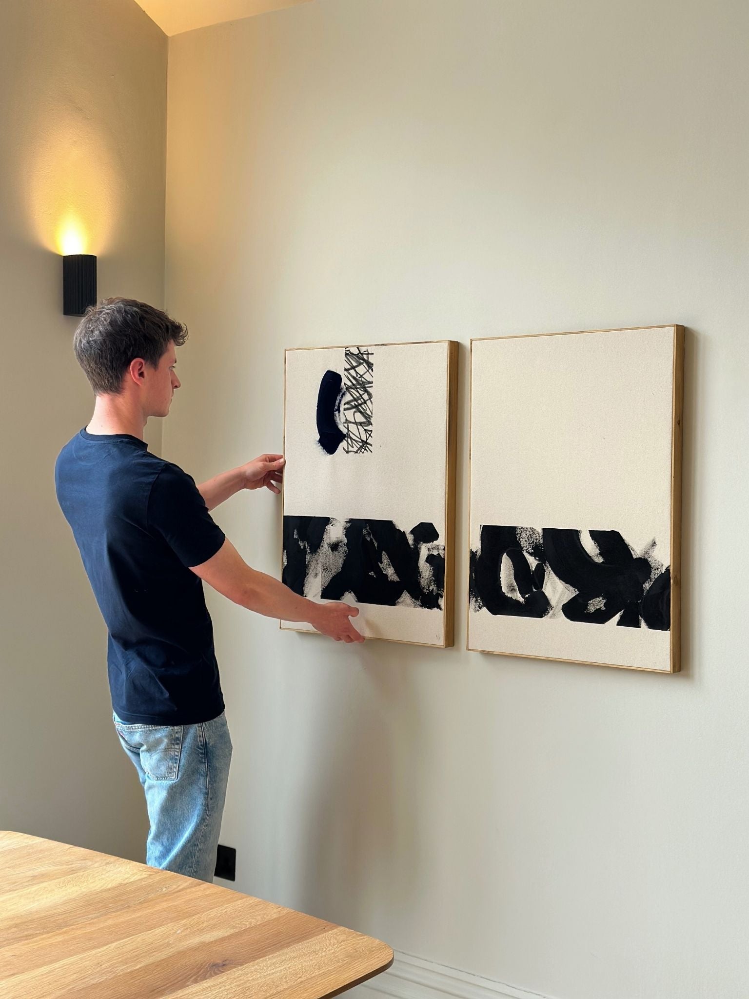 Two matching black and white abstract canvas artworks made using the Plan monochrome cotton double art kit, creating a cohesive wall art display in a minimalist living space.