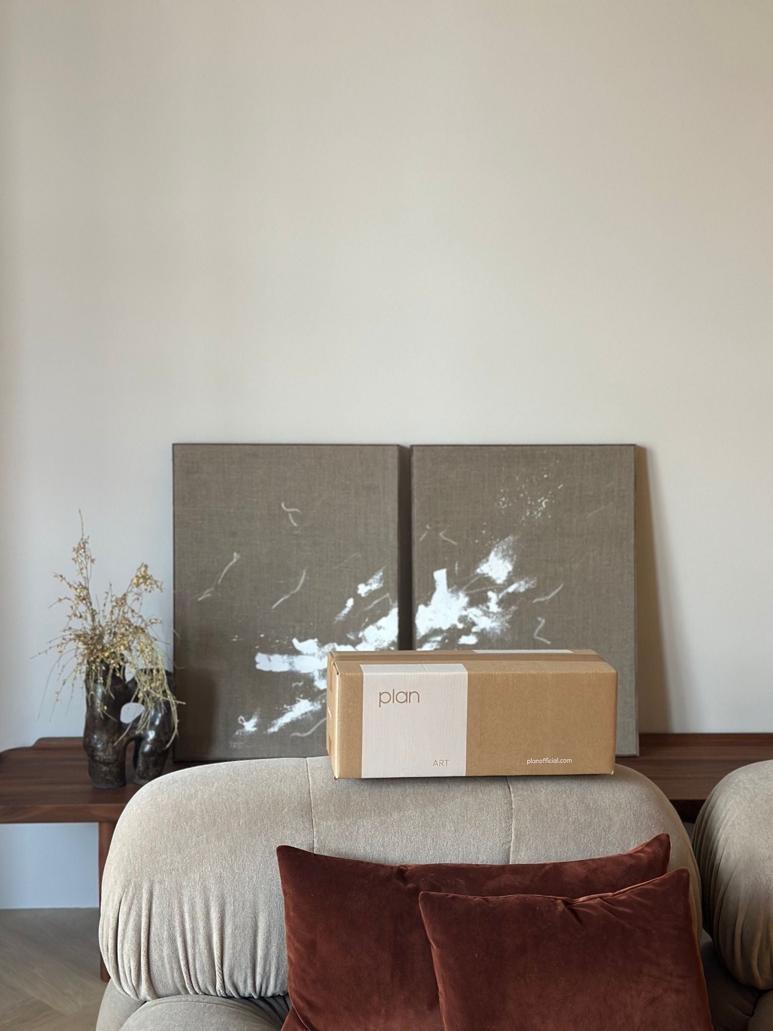 Finished monochrome linen framed canvas artworks styled as a matching pair in a minimalist living room interior, with a Plan DIY art box in front
