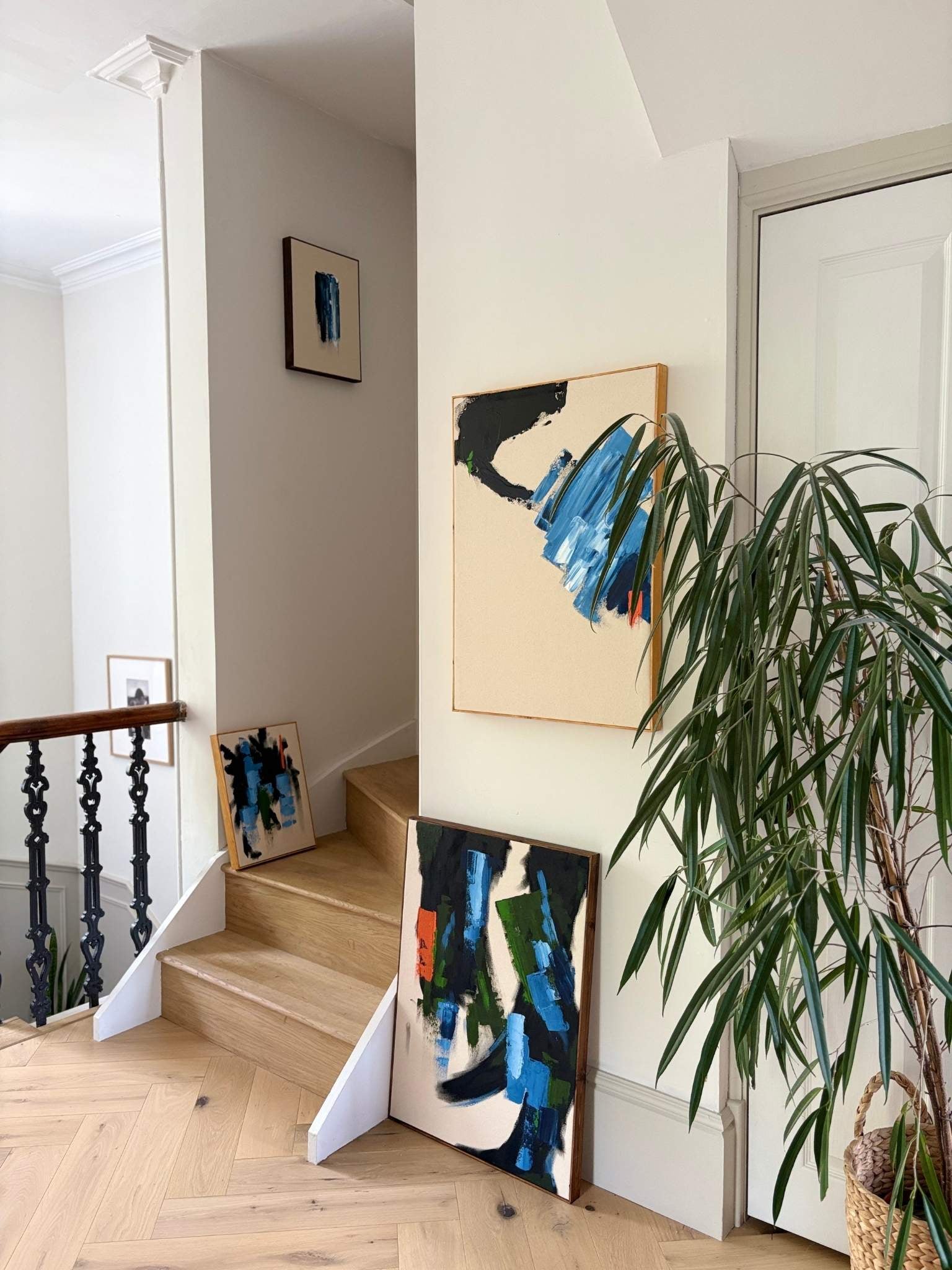 Finished artworks made using Navy & Bright double framed canvas art kit by Plan styled in a modern home interior, showing four abstract paintings displayed together to create a cohesive matching artwork set.