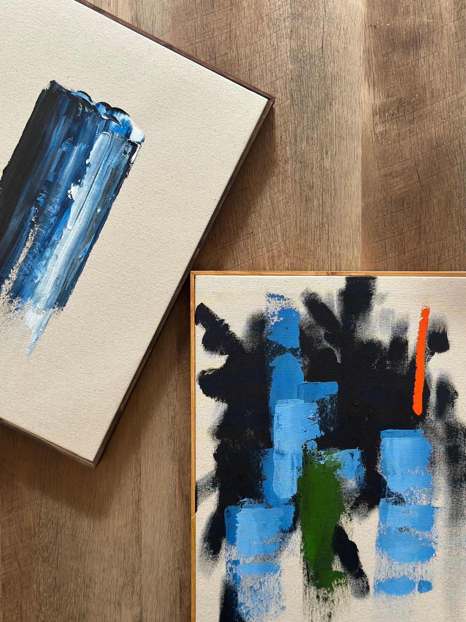 Close-up styling of two framed abstract canvas artworks from the Navy & Bright double art kit, showcasing expressive blue brushstrokes, deep contrast tones and premium oak edge framing.