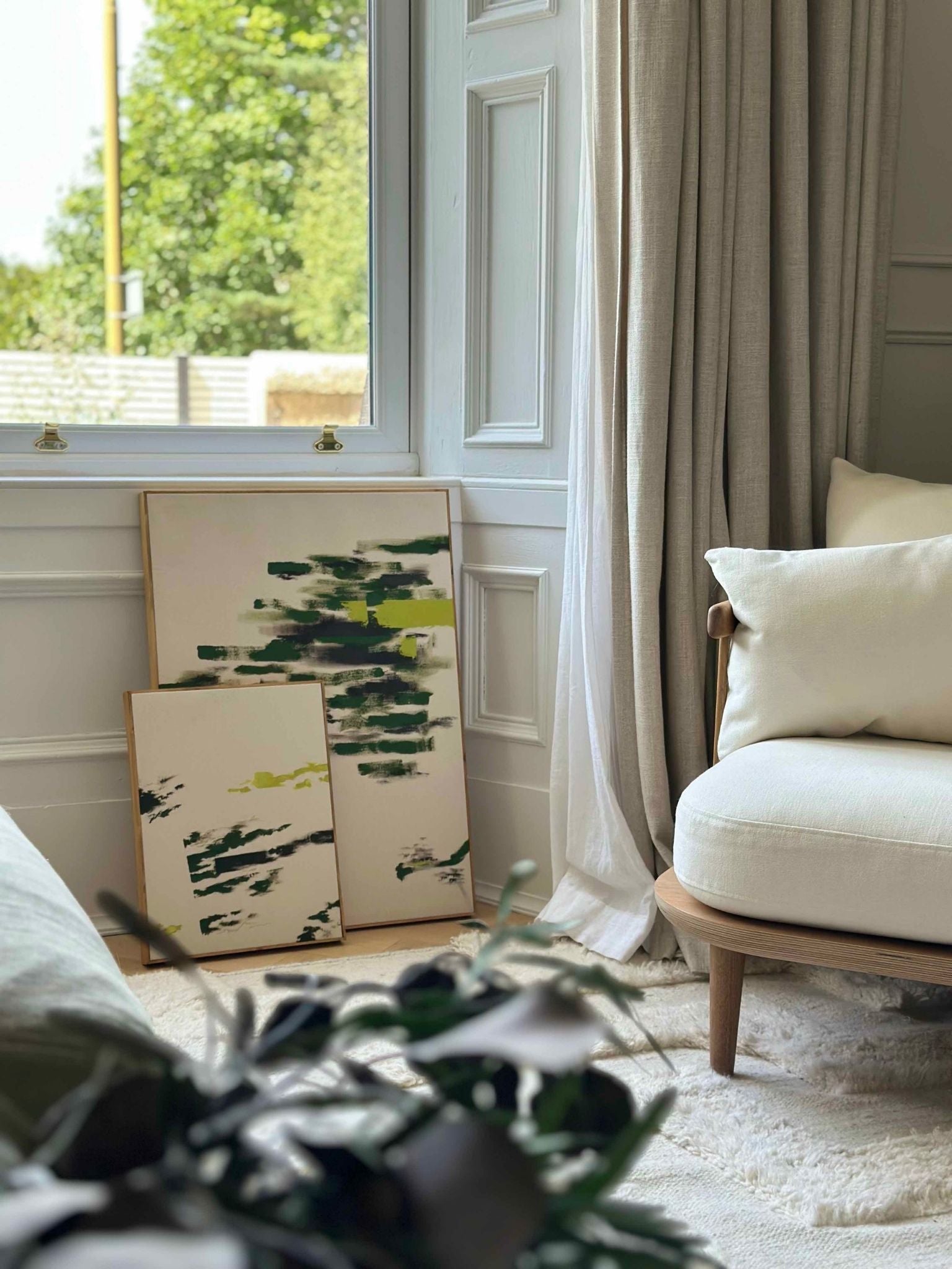 Finished olive abstract framed canvas artworks styled beneath a window with soft furnishings, demonstrating how a double art kit creates cohesive wall art.