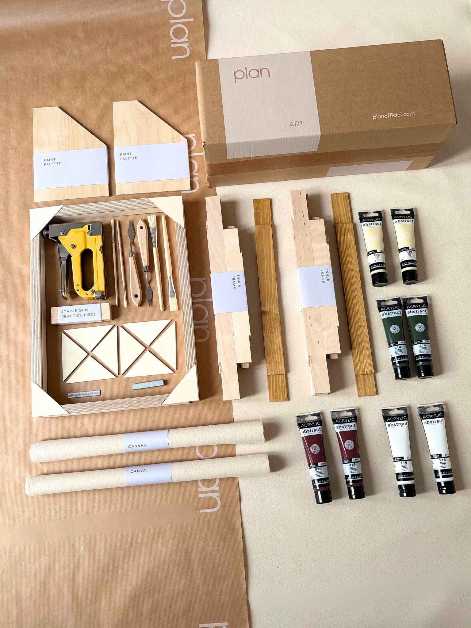 Forest Red small double framed canvas art kit showing everything you need to create your own art at home, including two canvases, handcrafted oak frames, acrylic paints, brushes and staple gun presented as a DIY art kit flat lay