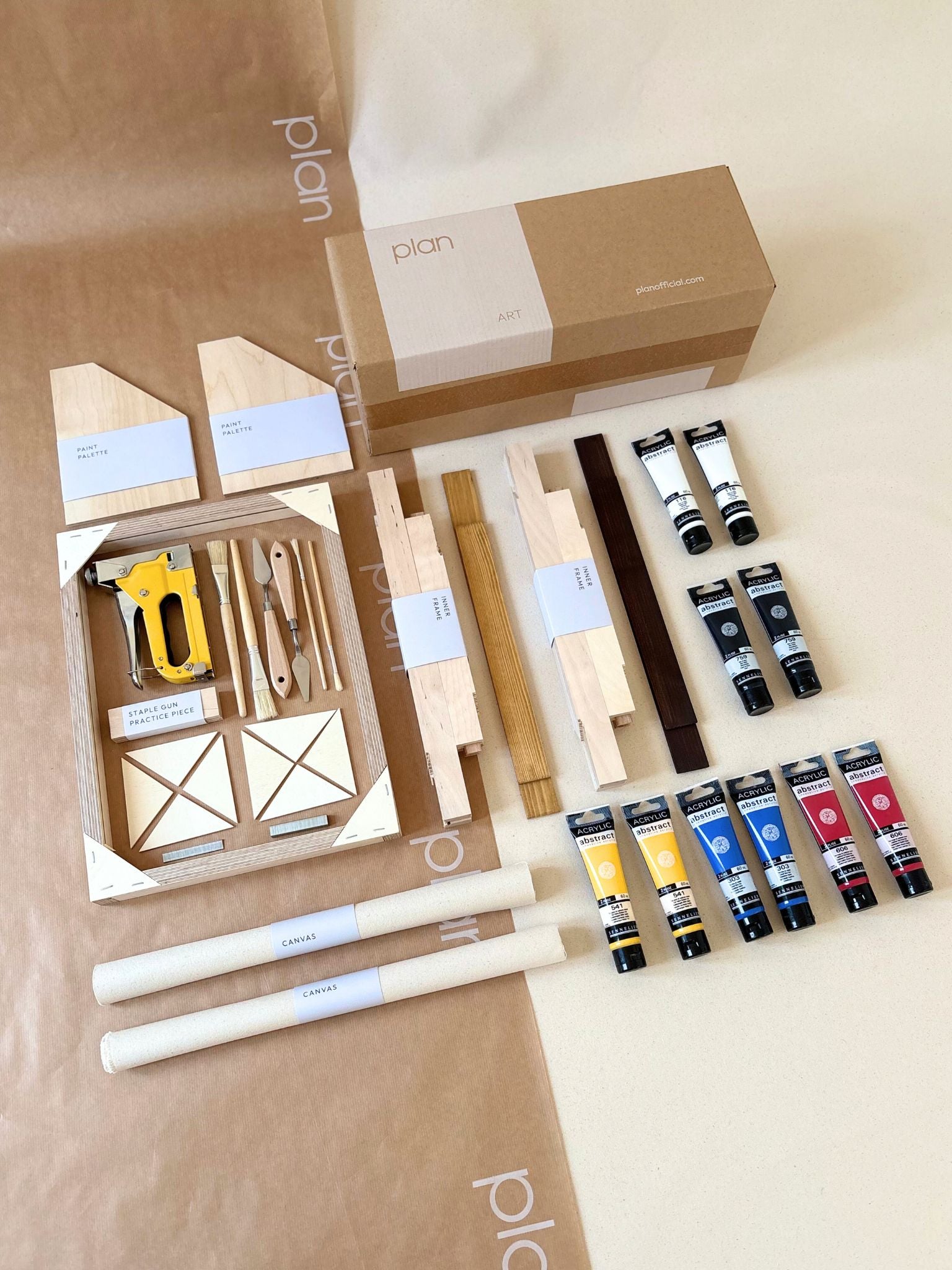 Two framed abstract artworks created with the MIX primary colours double art kit, featuring bold blue, red and yellow brushstrokes on raw cotton canvas with handcrafted oak and dark oak edge frames.