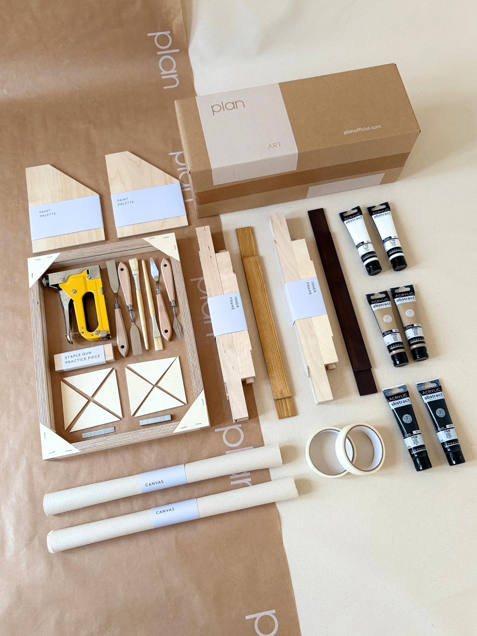 Finished monochrome abstract canvas artworks created with the Plan DIY framed canvas double art kit, shown being styled on the wall in a calm, modern home interior.