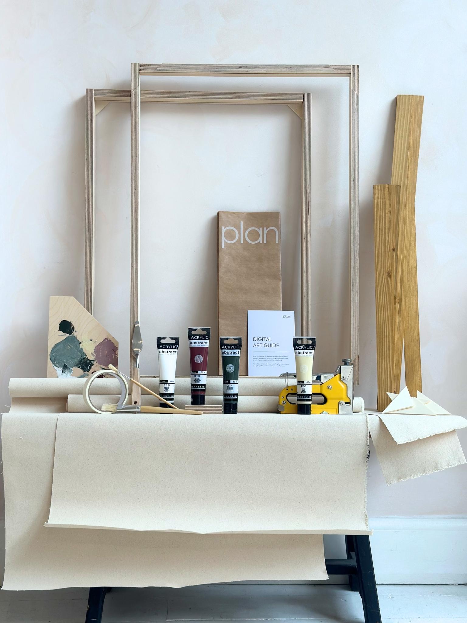 Everything you need to create your own framed artwork at home, shown as a Forest Red double framed canvas art kit with two canvases, handcrafted oak frames, acrylic paints, brushes, palette knives and staple gun.