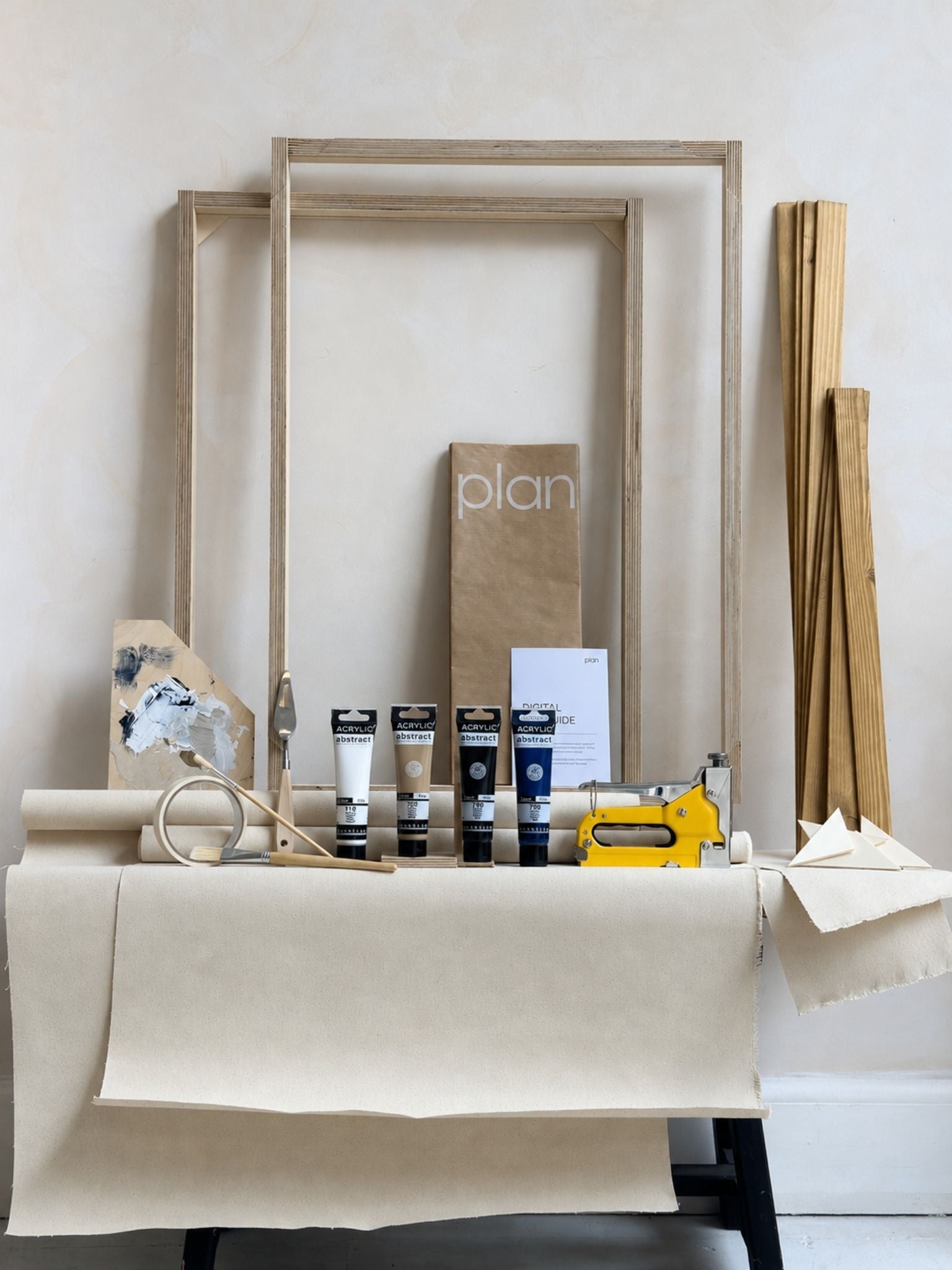 Finished monochrome abstract canvas artworks created with the Plan DIY framed canvas double art kit, shown being styled on the wall in a calm, modern home interior.