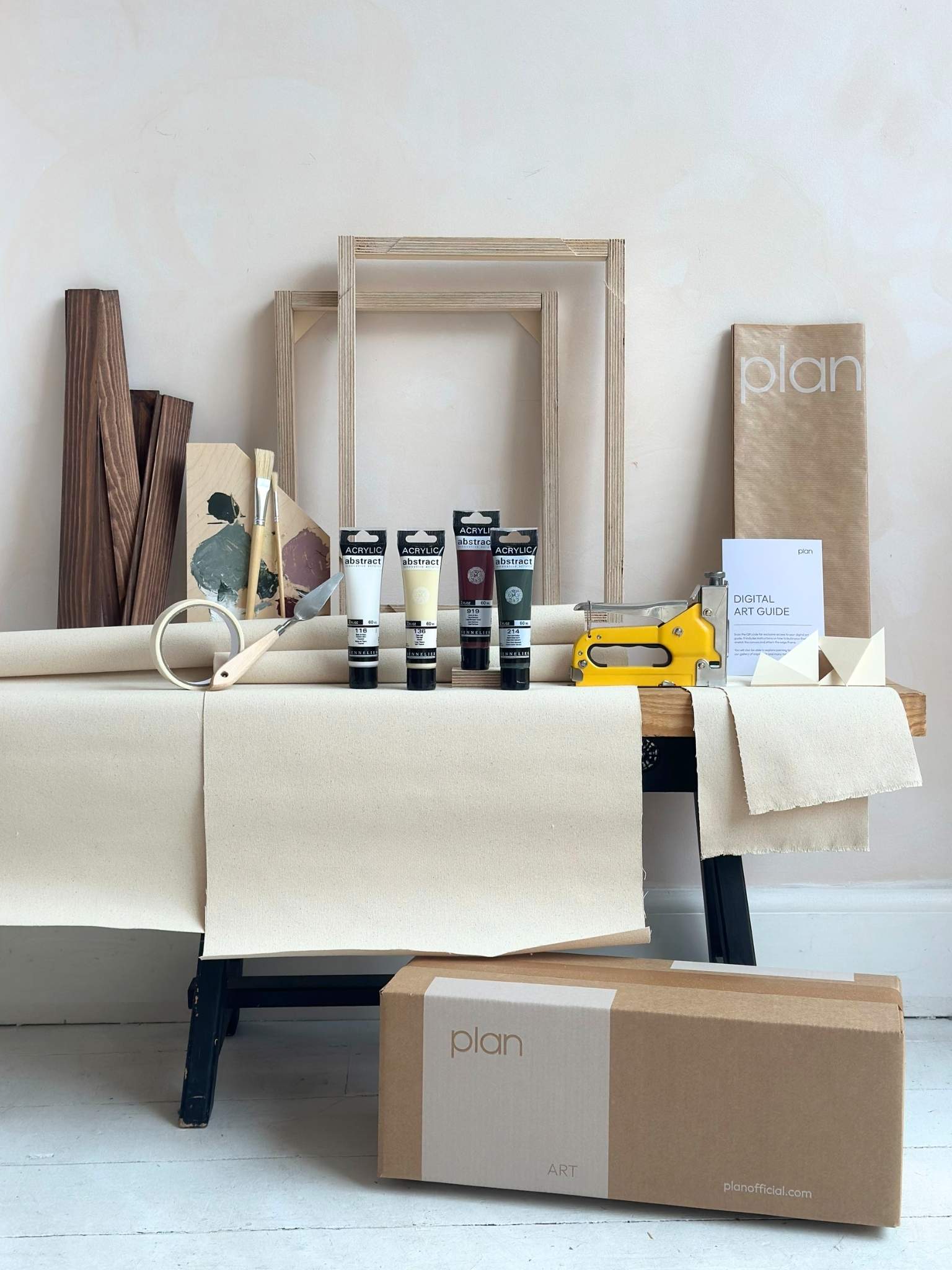 Everything you need to create your own framed artwork at home, shown as a Forest Red small double canvas art kit with dark oak frames, canvases, acrylic paints and painting tools.