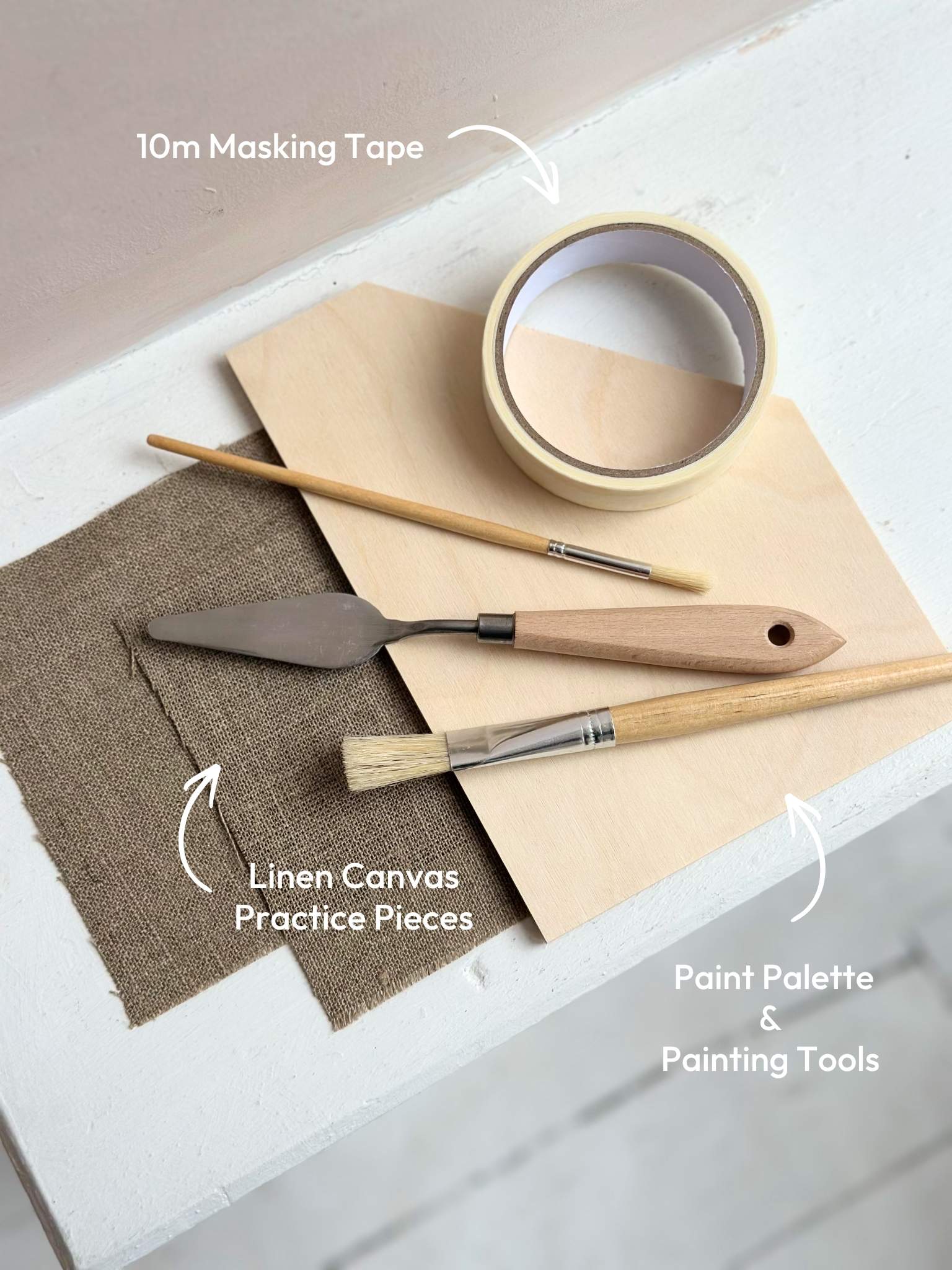 DIY art kit tools including paint palette, brushes, palette knife, masking tape and linen canvas practice pieces for creating abstract art at home.
