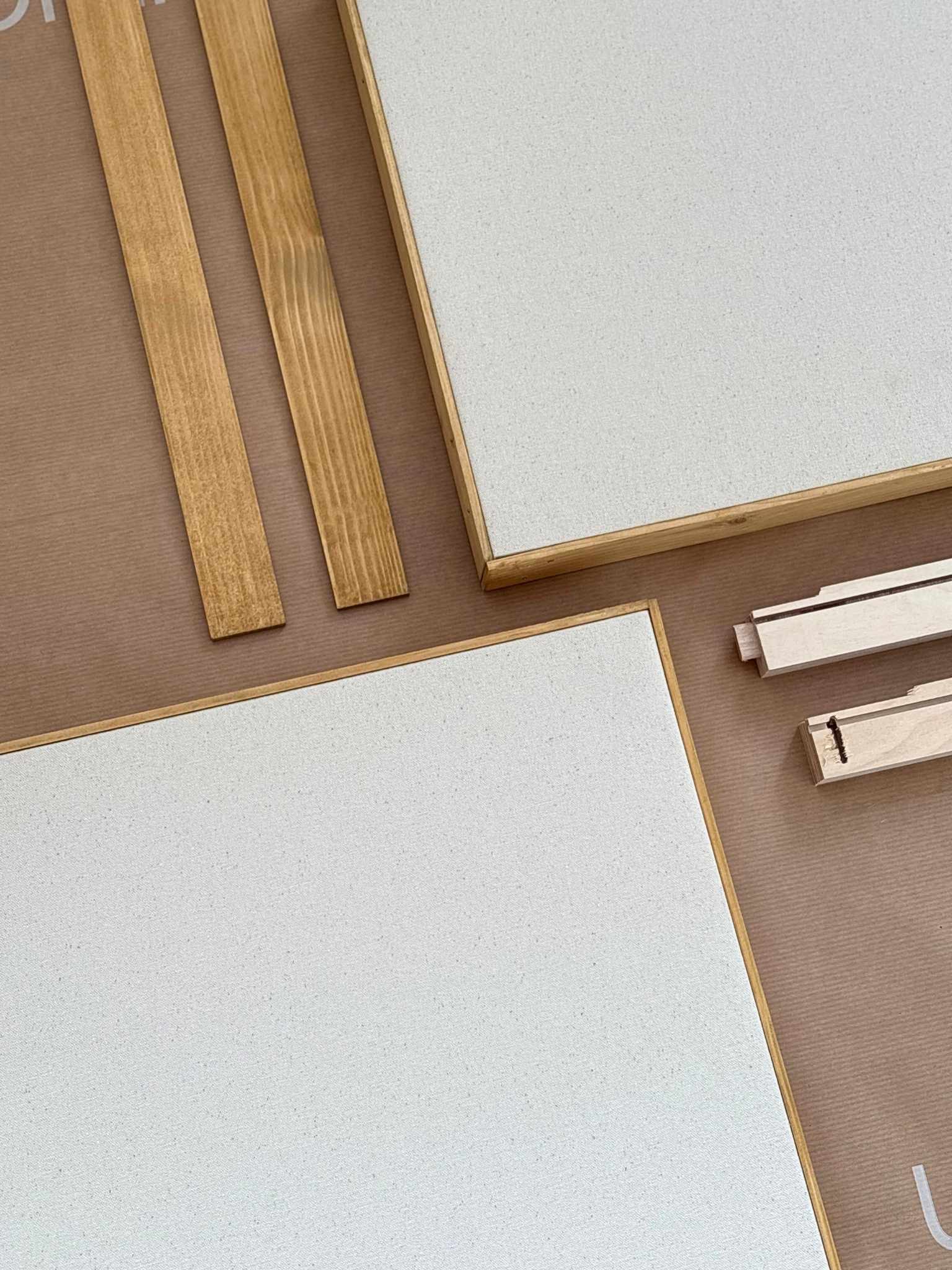 Blank framed cotton canvas art kit laid out flat, showing two stretched cotton canvases with handcrafted wooden frames and custom inner frame components, part of a DIY framed canvas art kit for creating your own artwork at home