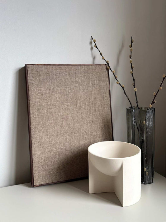 Framed linen canvas styled in minimalist neutral home, illustrating the build-it-yourself frame process of the linen canvas art kit