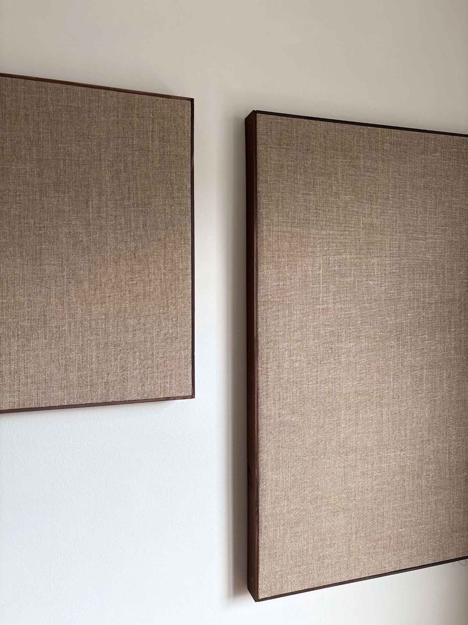 Framed linen canvas artwork hung on a wall, highlighting the slim wooden edge frame and natural linen texture from a DIY framed canvas kit